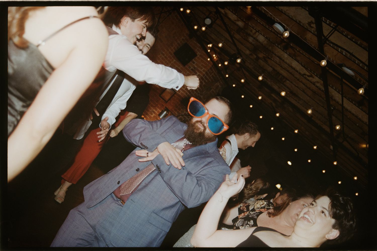 A series of vintage film photographs showing people dancing at a party with twinkling lights in the background.