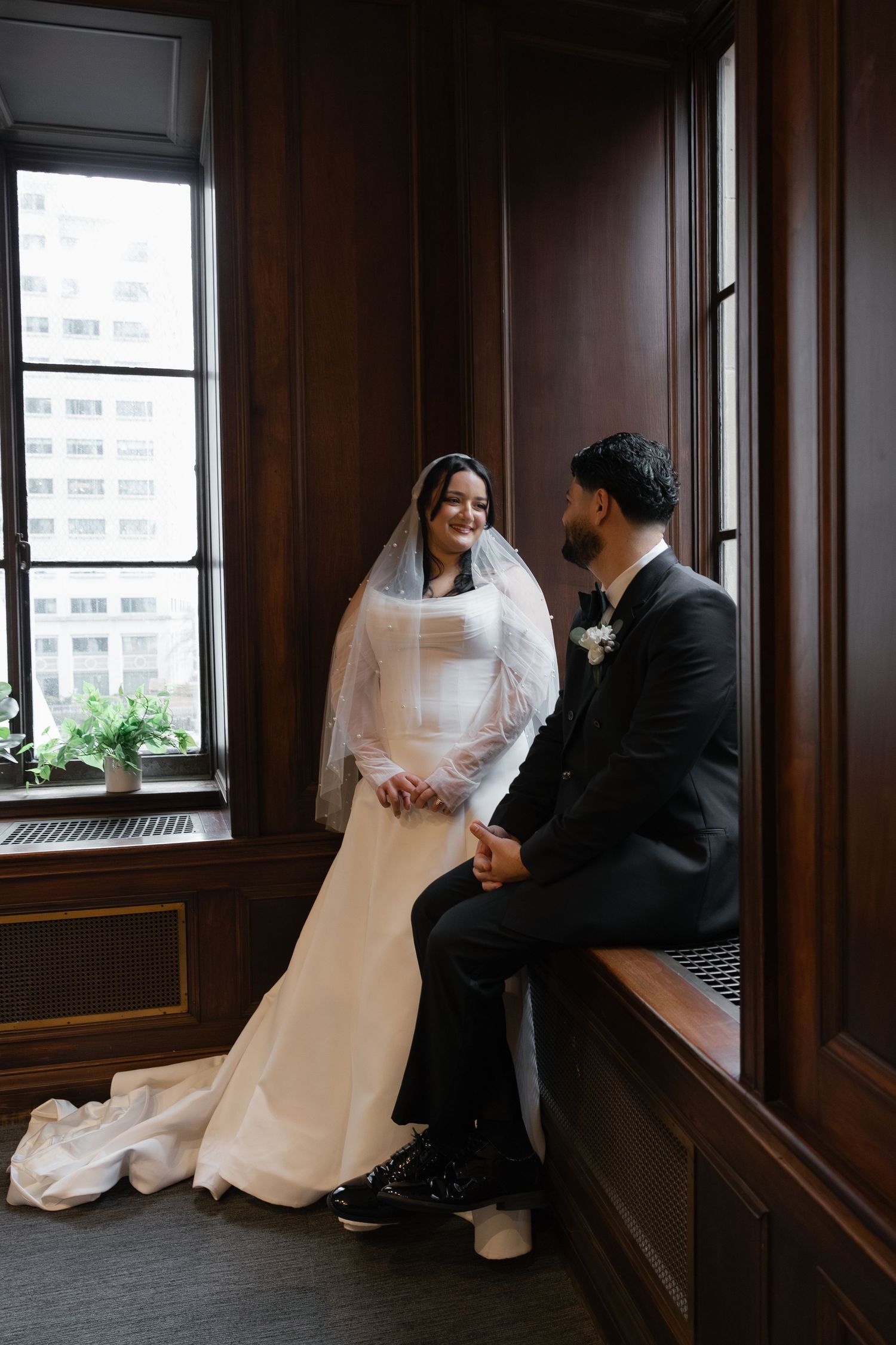 Elegant wedding portraits captured near windows with natural light streaming in. Arbor Midtown wedding photographer