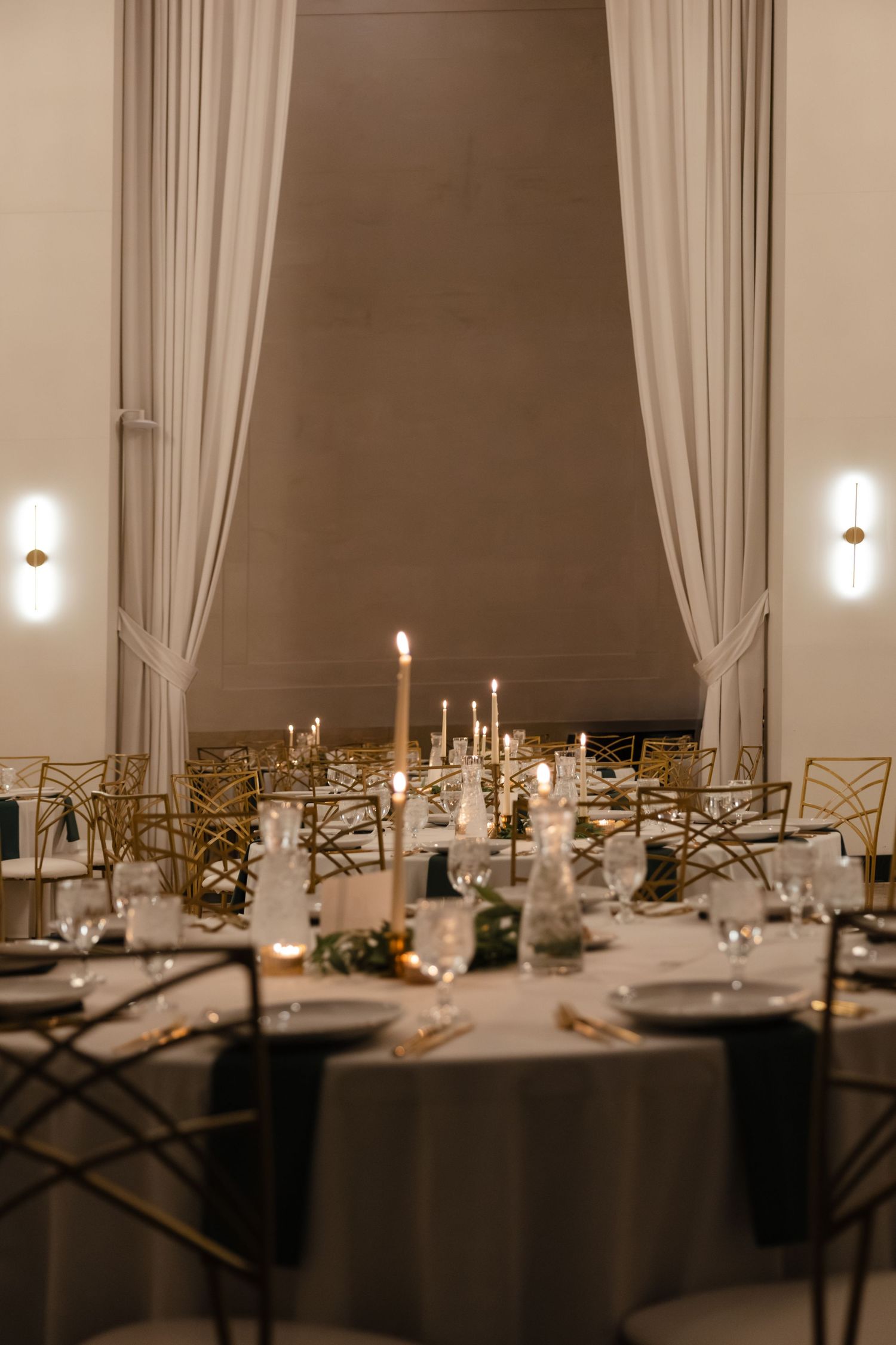 An elegant wedding reception table setting with candles and gold accents. Arbor Midtown wedding photographer