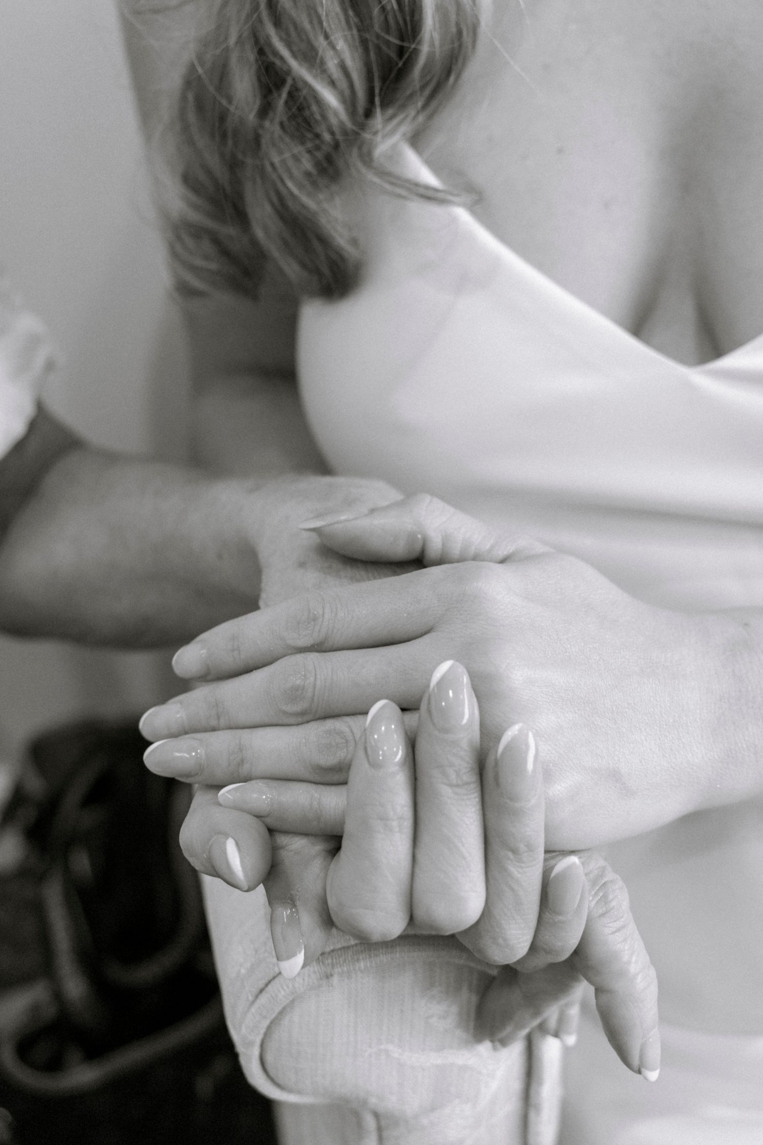 Artistic black and white close-up of hands with elegant manicured nails. Film wedding photographer NY