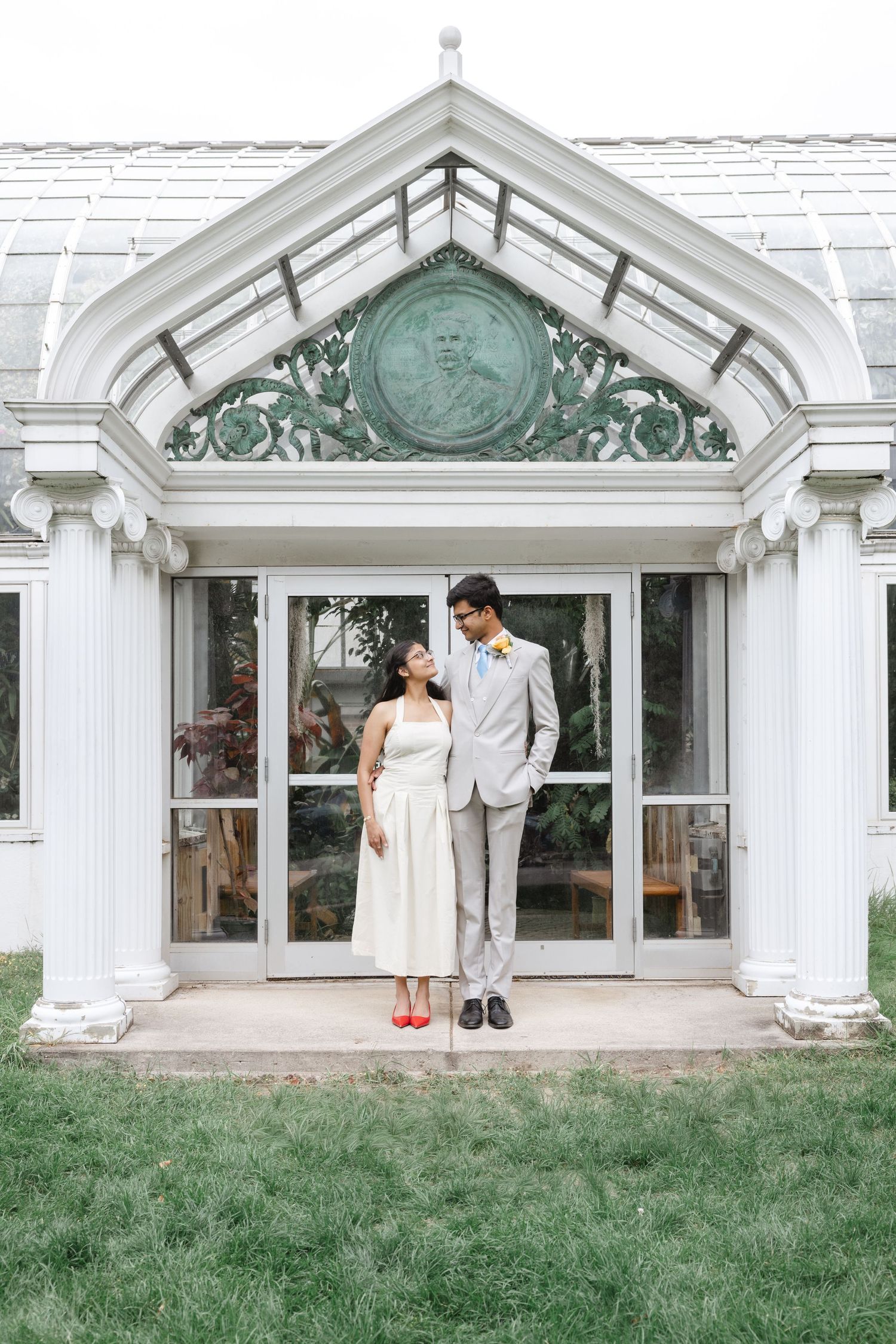 Sequence of dance moves performed by a couple in front of a white conservatory building. Highland Park elopement photographer Rochester  NY