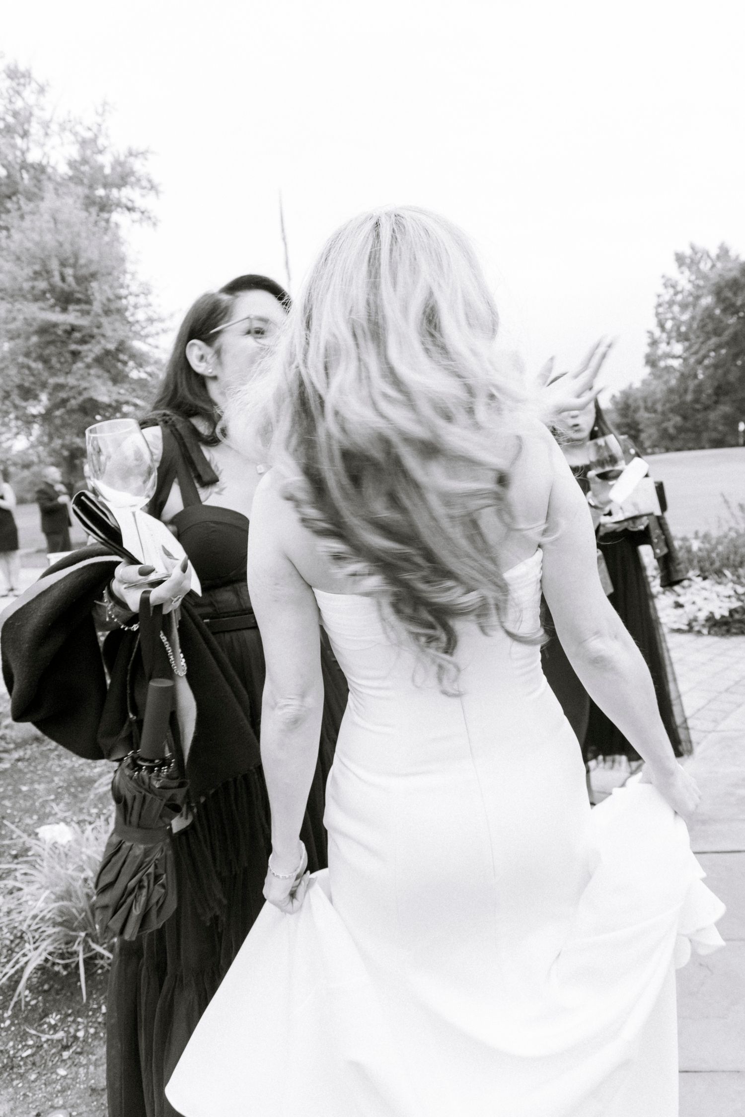 Wedding party in formal attire posing outdoors in black and white. Rochester NY documentary wedding photography