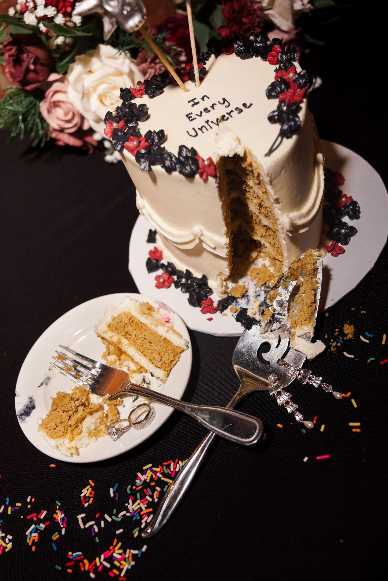 A birthday cake decorated with fresh berries and flowers, with a message written on it.