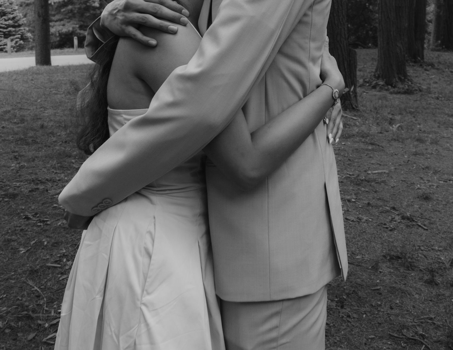 An intimate black and white series of a couple embracing in a wooded area. Rochester conservatory elopement photographer