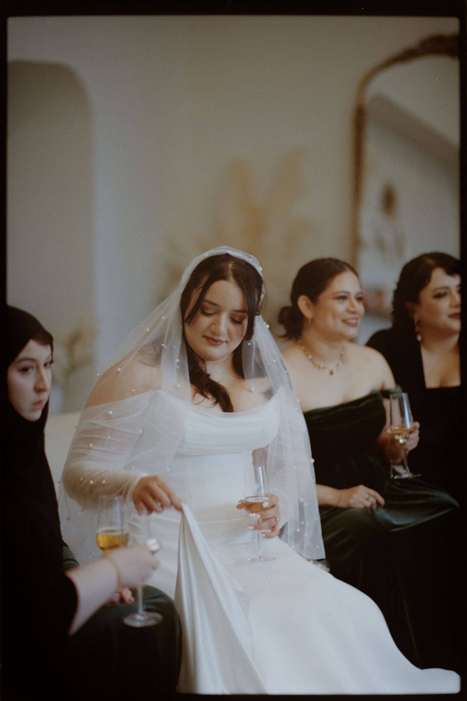 Wedding celebration scene with guests in formal attire enjoying champagne.