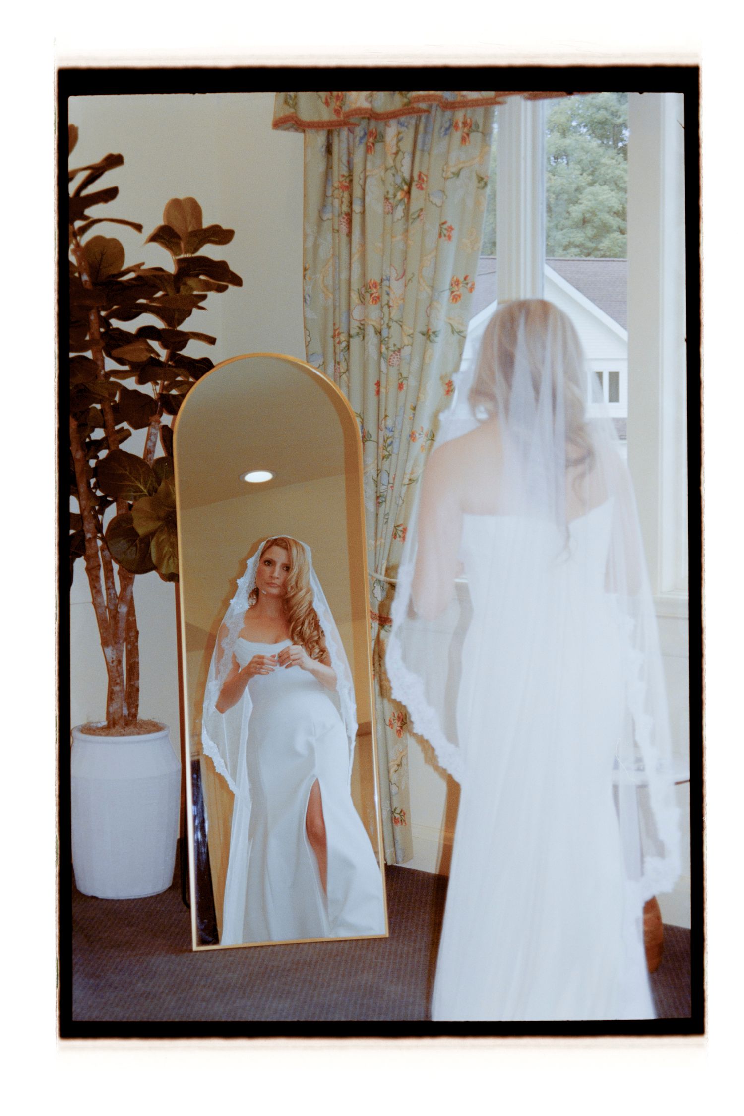 Vintage-style photographs of a wedding dress and veil reflected in a full-length mirror.