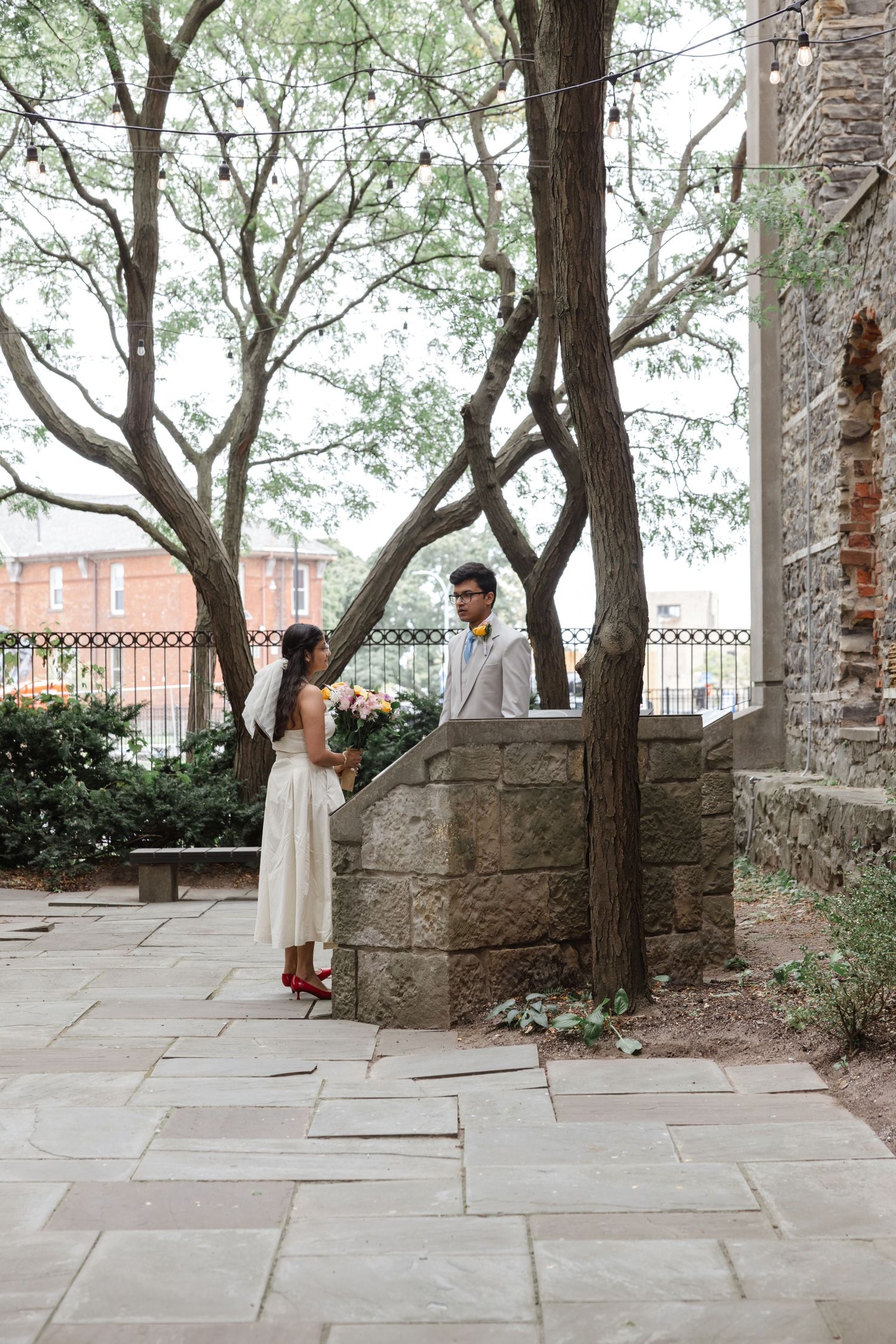 Stone courtyard with trees creating natural archways and stone wall details.  St. Josephs park wedding photographer