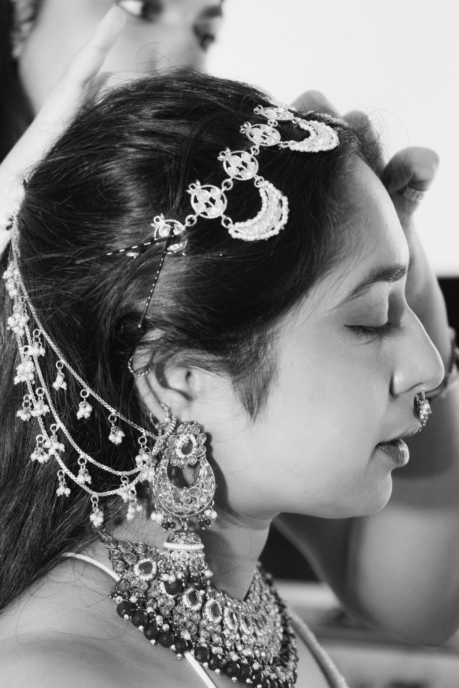 Ornate bridal jewelry and hair accessories shown in black and white profile shots. Ithaca outdoor wedding photographer