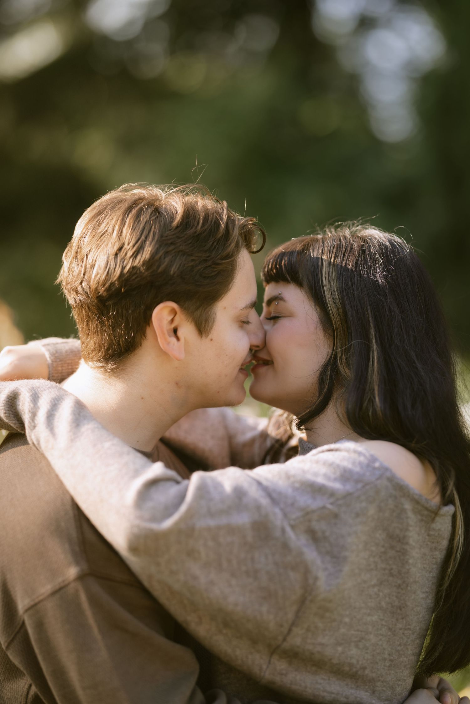 A tender moment shared between a couple in a natural outdoor setting. Rochester NY documentary engagement photography