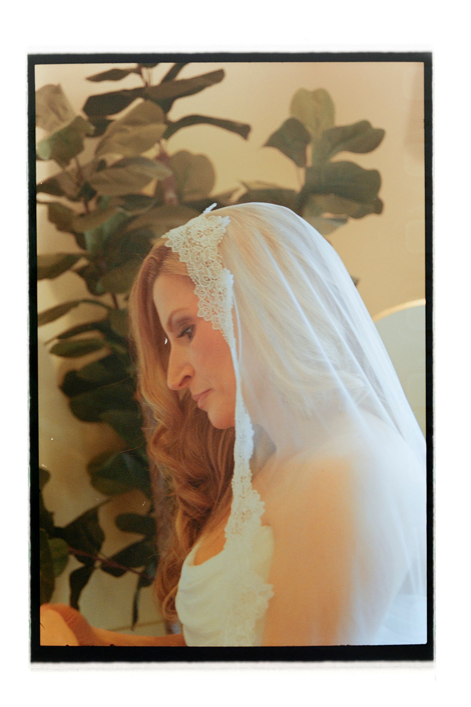 Delicate white bridal veil with lace details against neutral background.Rochester NY Film wedding photography