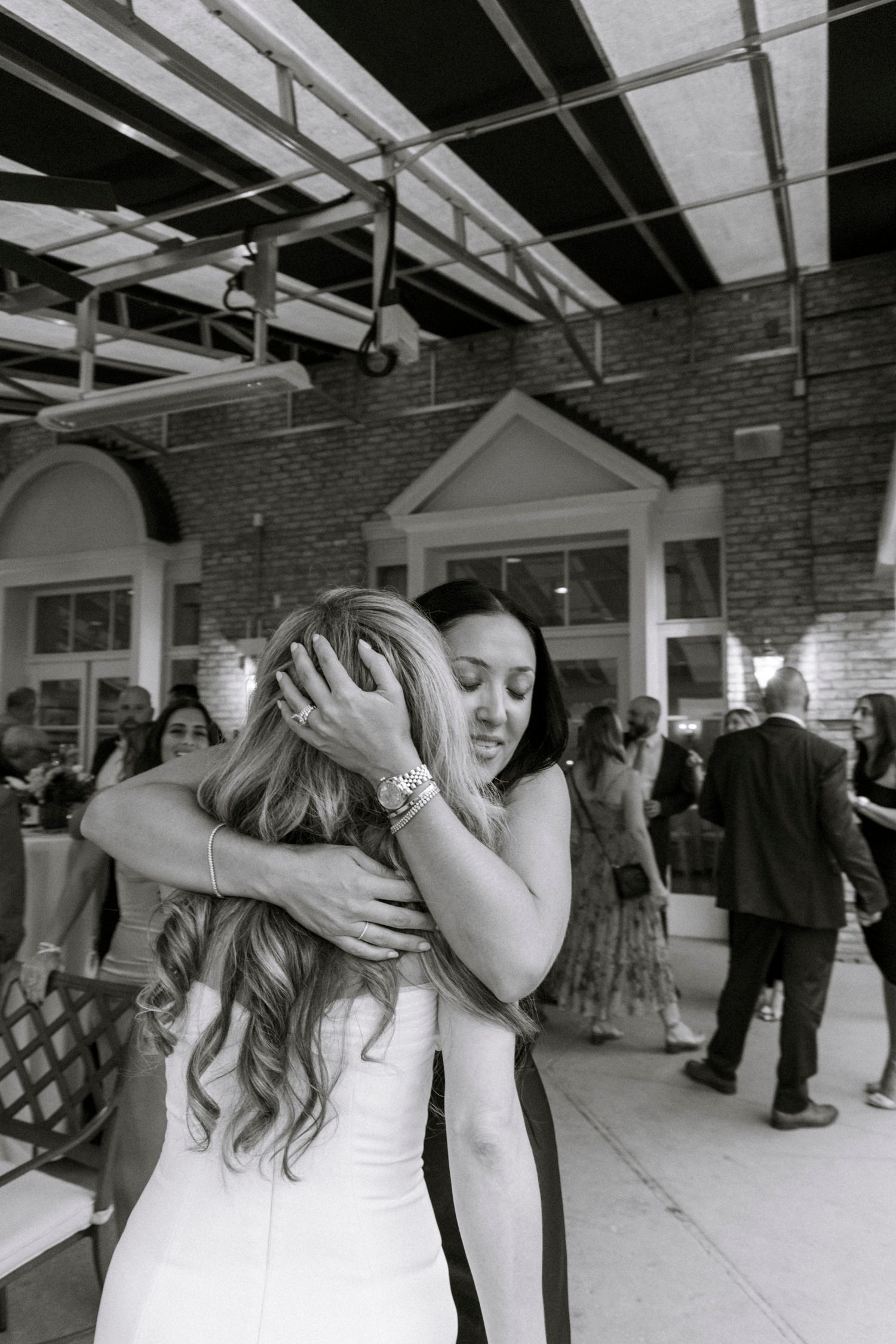 Wedding guests dancing and celebrating on an indoor dance floor. Rochester NY documentary wedding photography