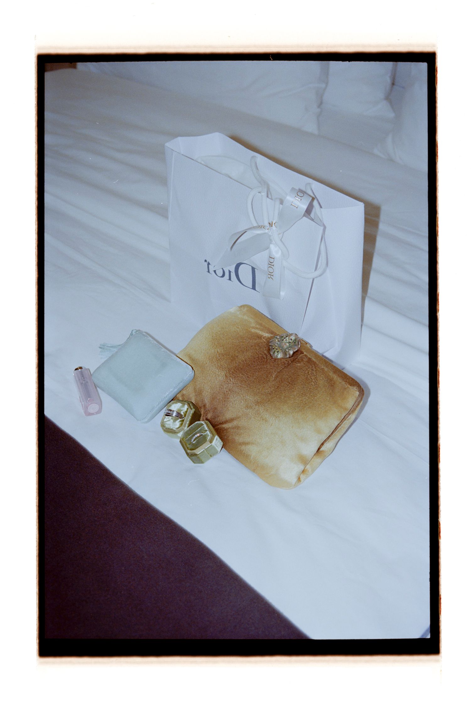 Shopping bags and gift items arranged on a white surface. Rochester NY Film wedding photography