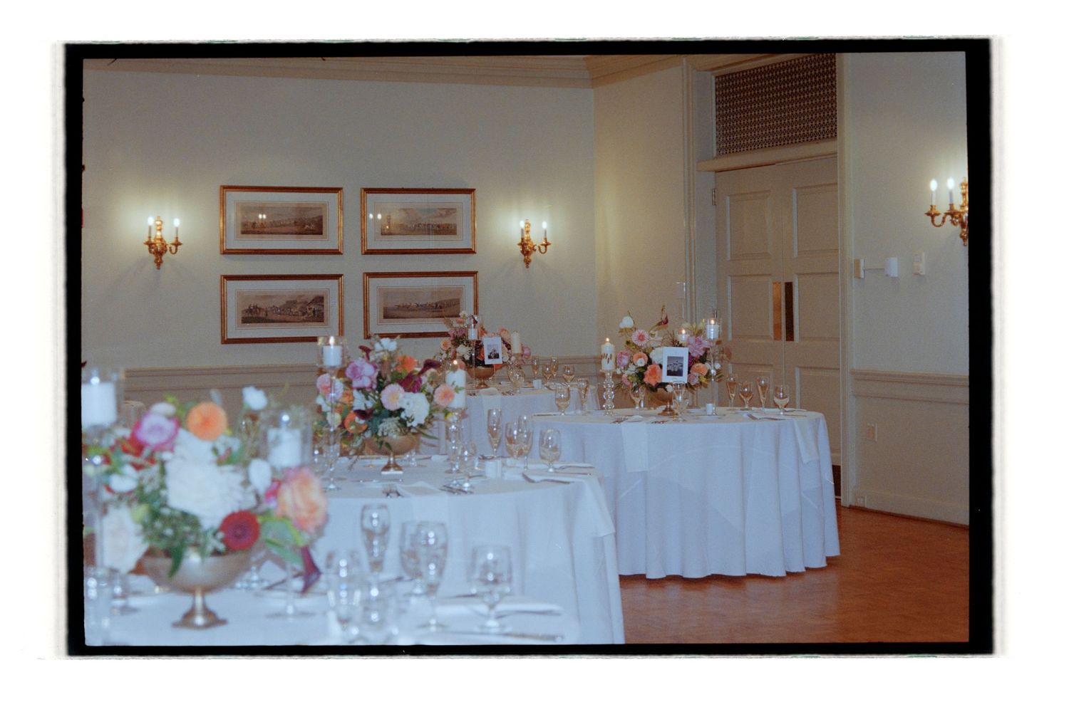 Wedding reception hall with white tablecloths and elegant place settings. Rochester NY Film wedding photography