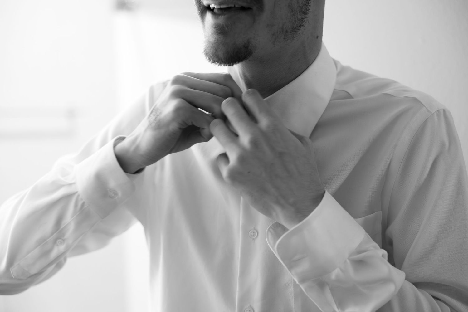 A sequence of black and white photos showing someone in a white shirt laughing and reacting with various expressions.