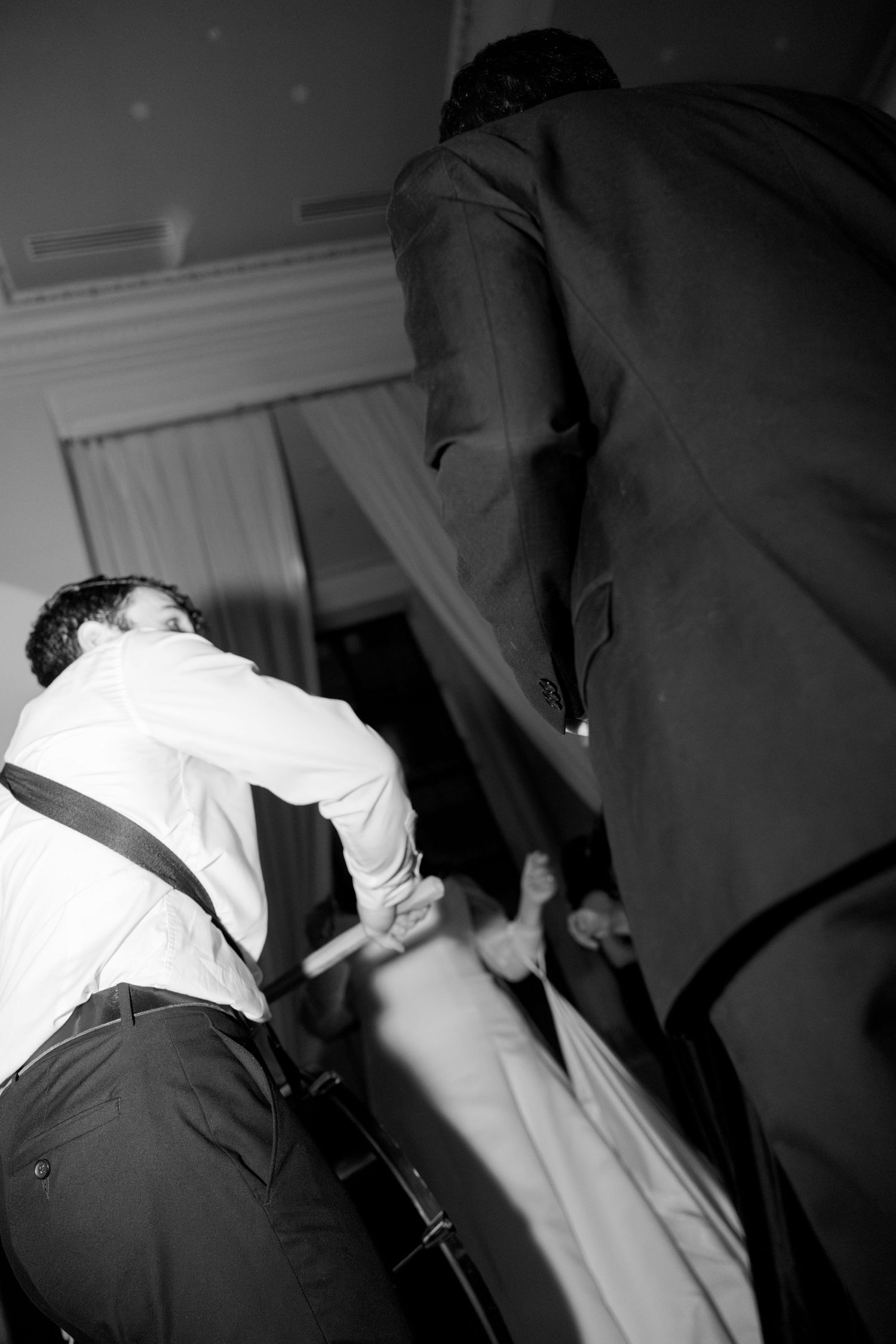 Black and white sequence showing energetic dance moves at a wedding party. Rochester NY film wedding photographer