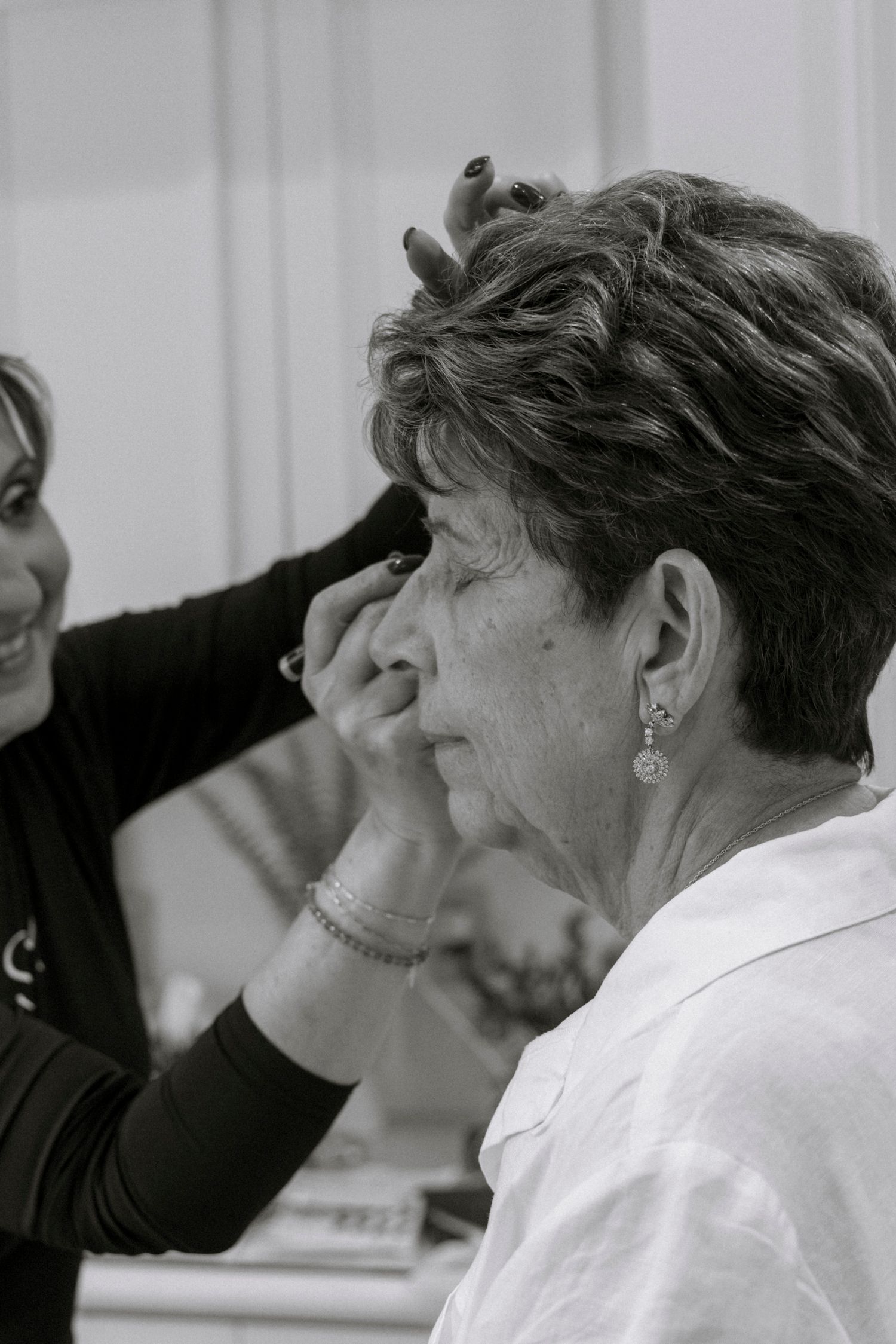 Black and white image showing people in an emotional moment during an event.Rochester NY documentary wedding photographer