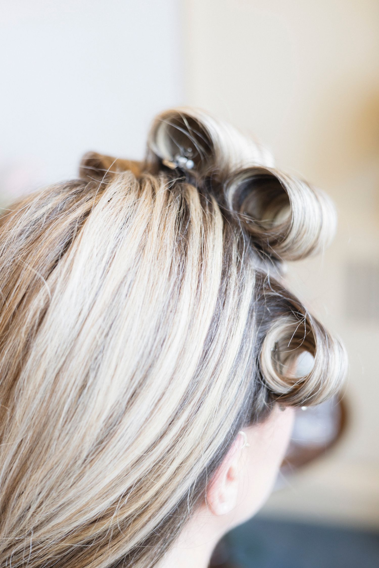 Close-up of blonde hair styled in an elegant updo with soft waves and texture.Rochester NY documentary wedding photography