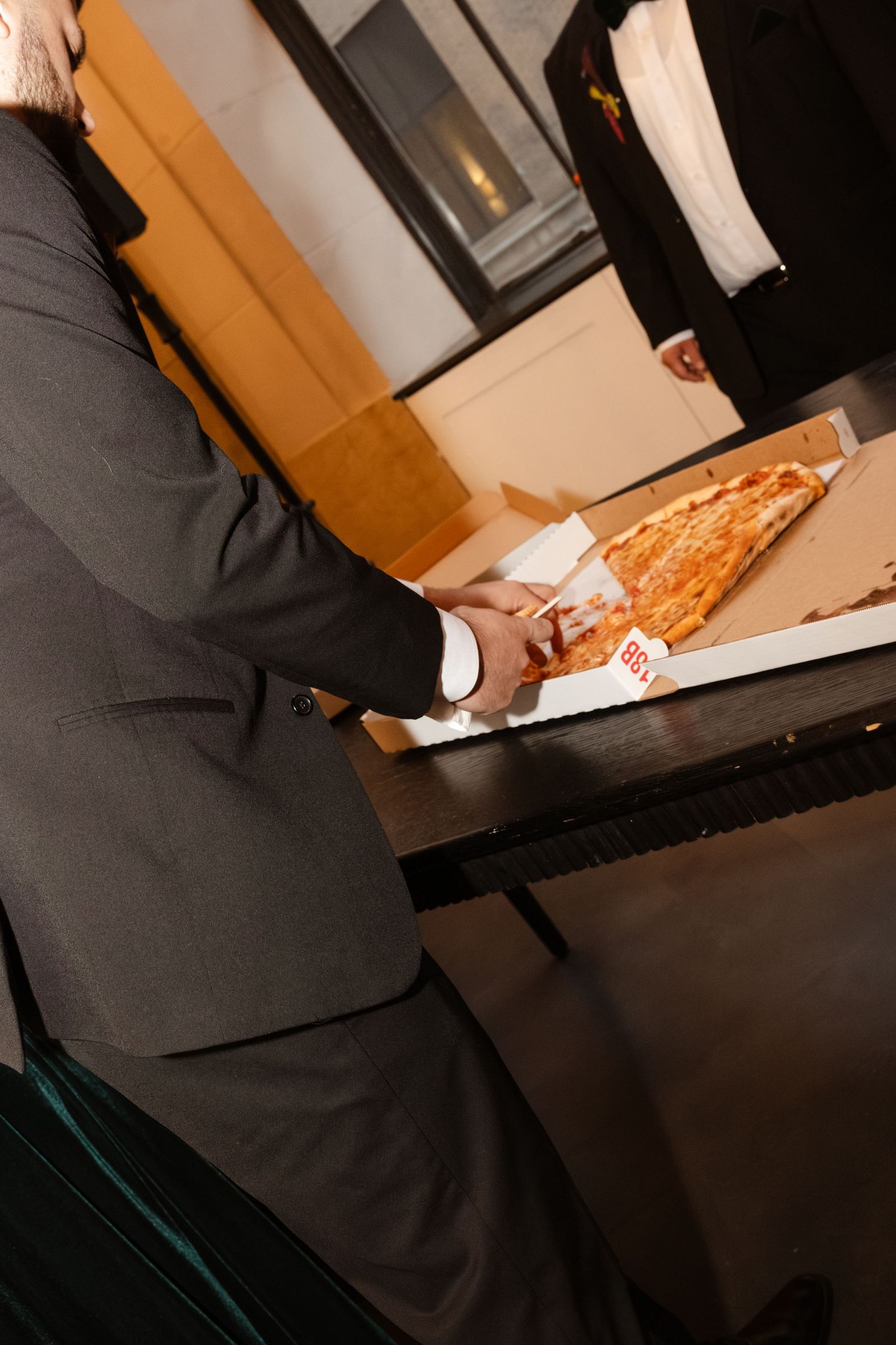 A couple cutting into their wedding cake together at an elegant reception. Arbor Midtown wedding photographer