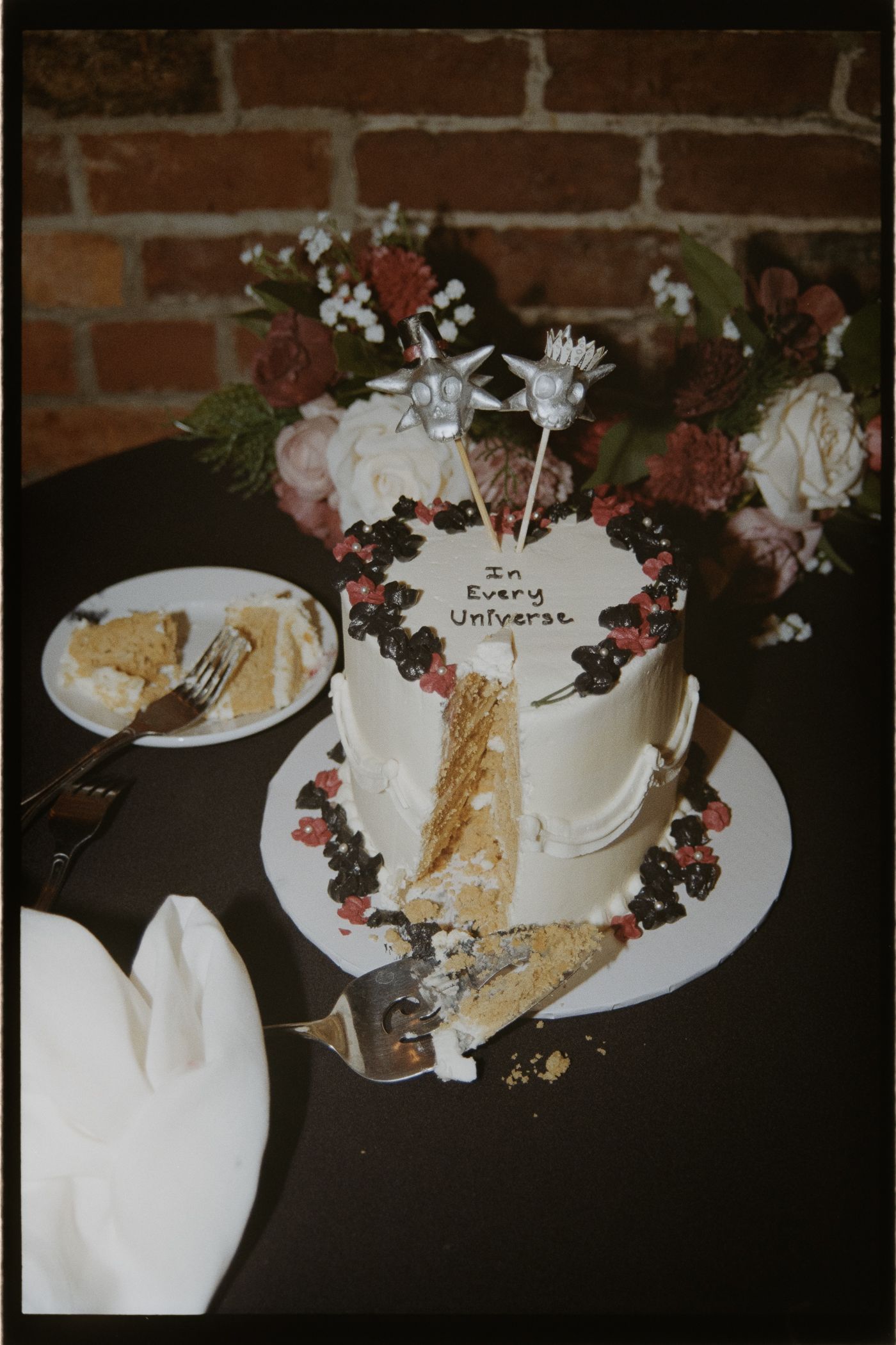 Time-lapse sequence shows a slice of white cake being eaten from a plate decorated with berries and floral accents.