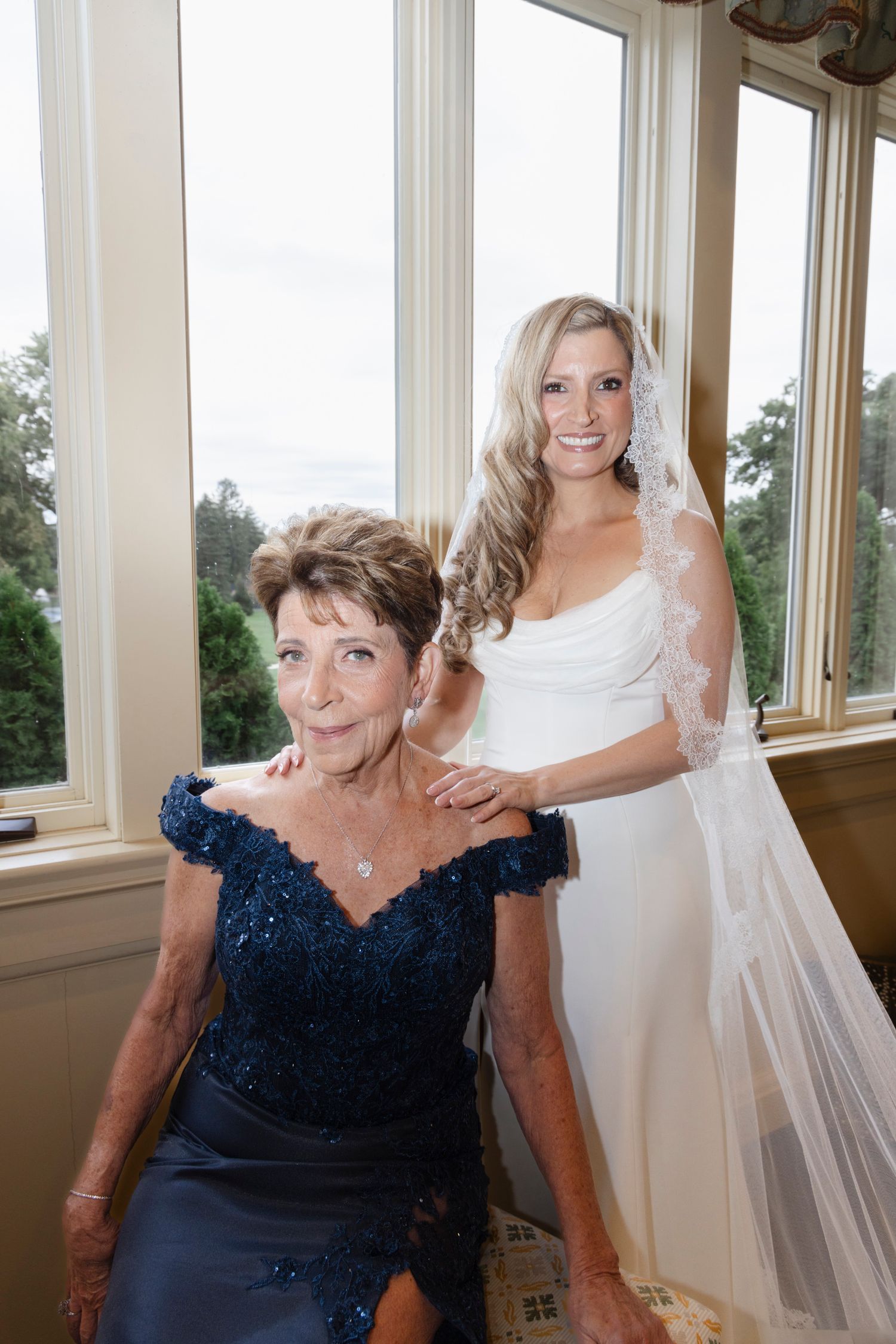 A touching moment between two people in formal attire during wedding preparations.Rochester NY documentary wedding photography
