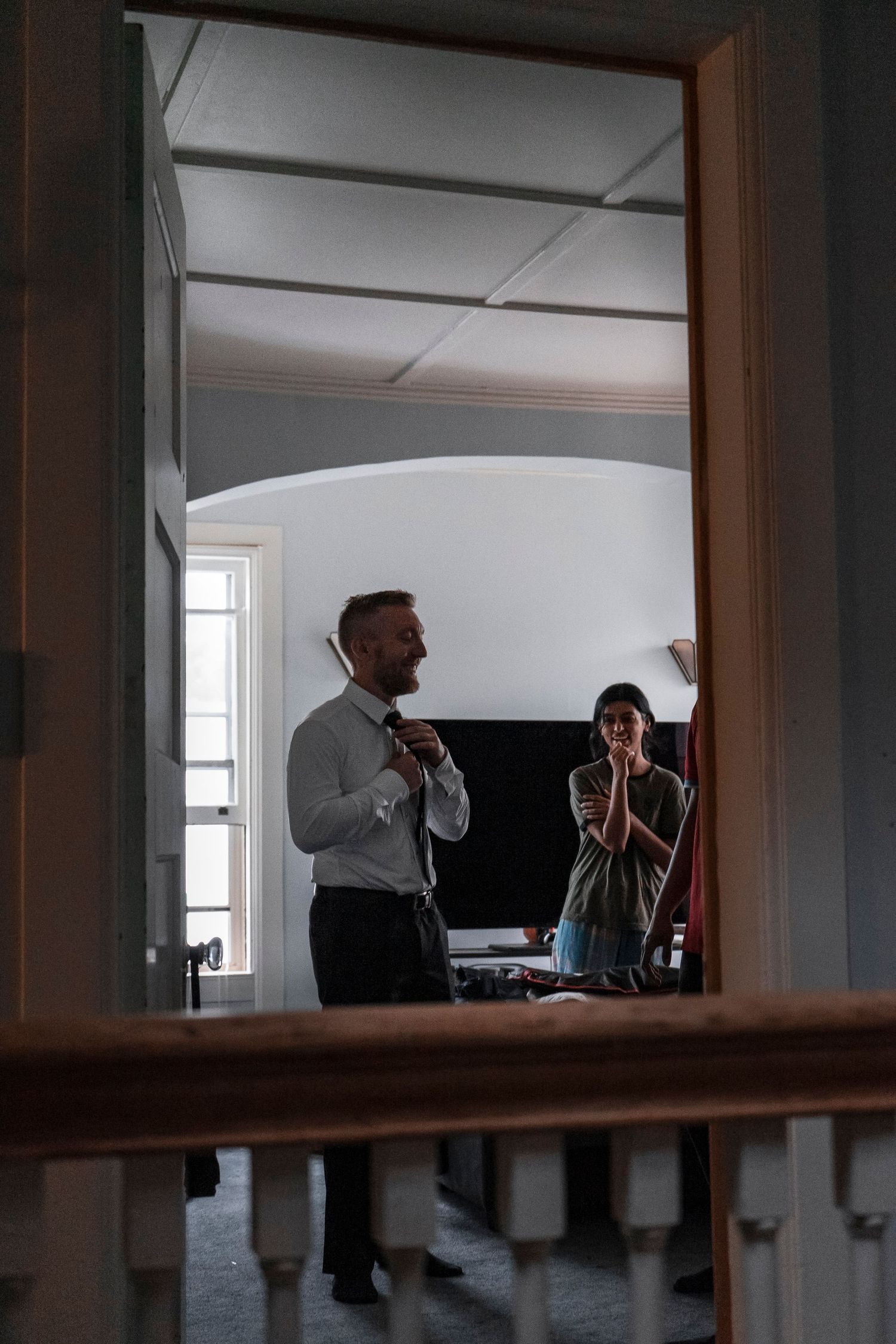 Interior view of a reception venue with dark wood trim and white walls. Ithaca outdoor wedding photographer