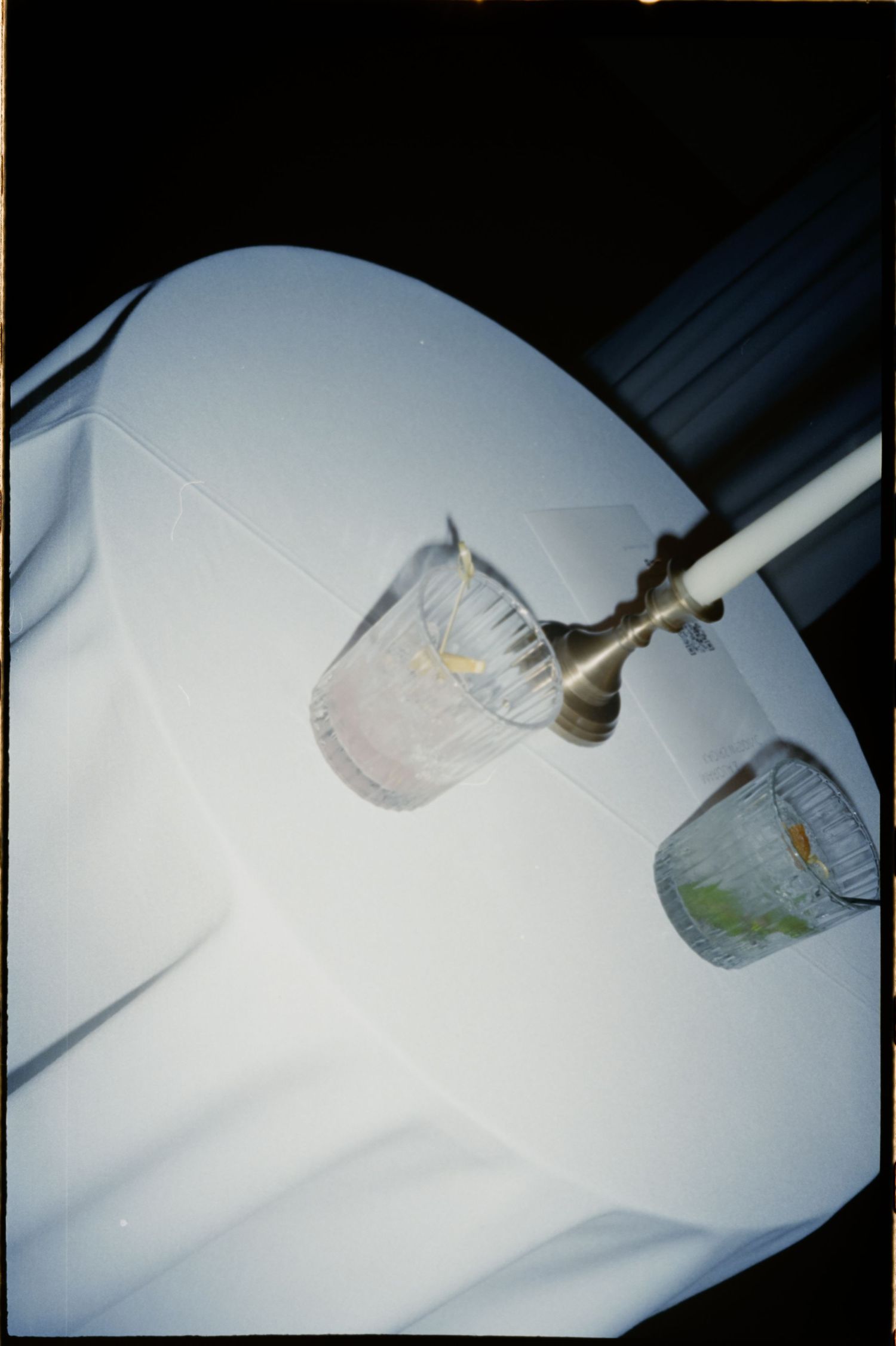 Abstract artistic shots of glassware on white tablecloth with dramatic lighting. Rochester NY film wedding photographer