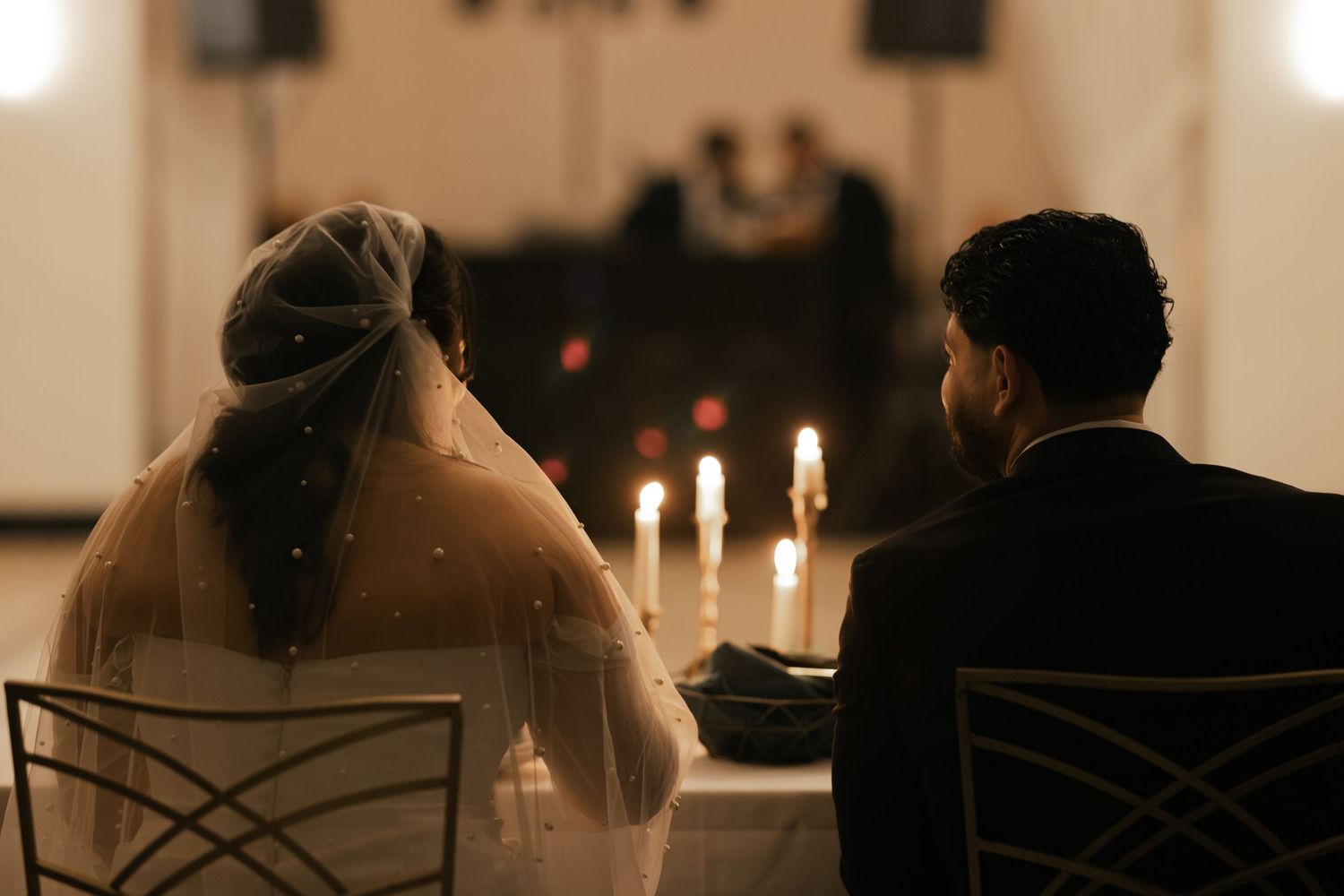 Romantic candlelit wedding reception setting with soft lighting and elegant decor. Arbor Midtown wedding photographer