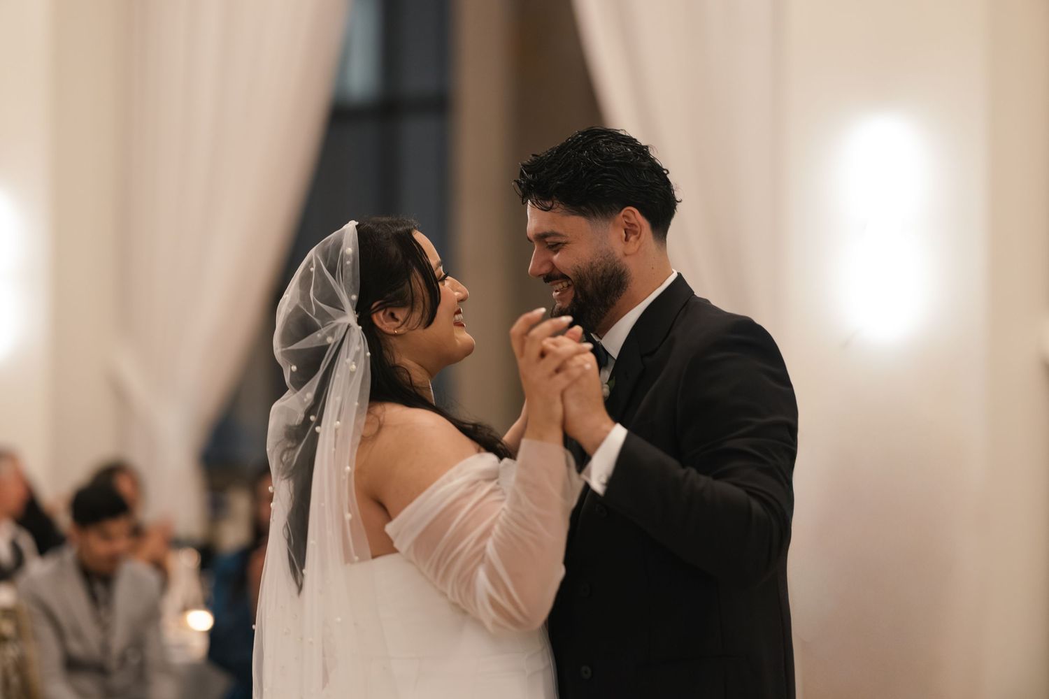 Wedding couple sharing an intimate moment during their ceremony in a light-filled room. Arbor Midtown wedding photographer