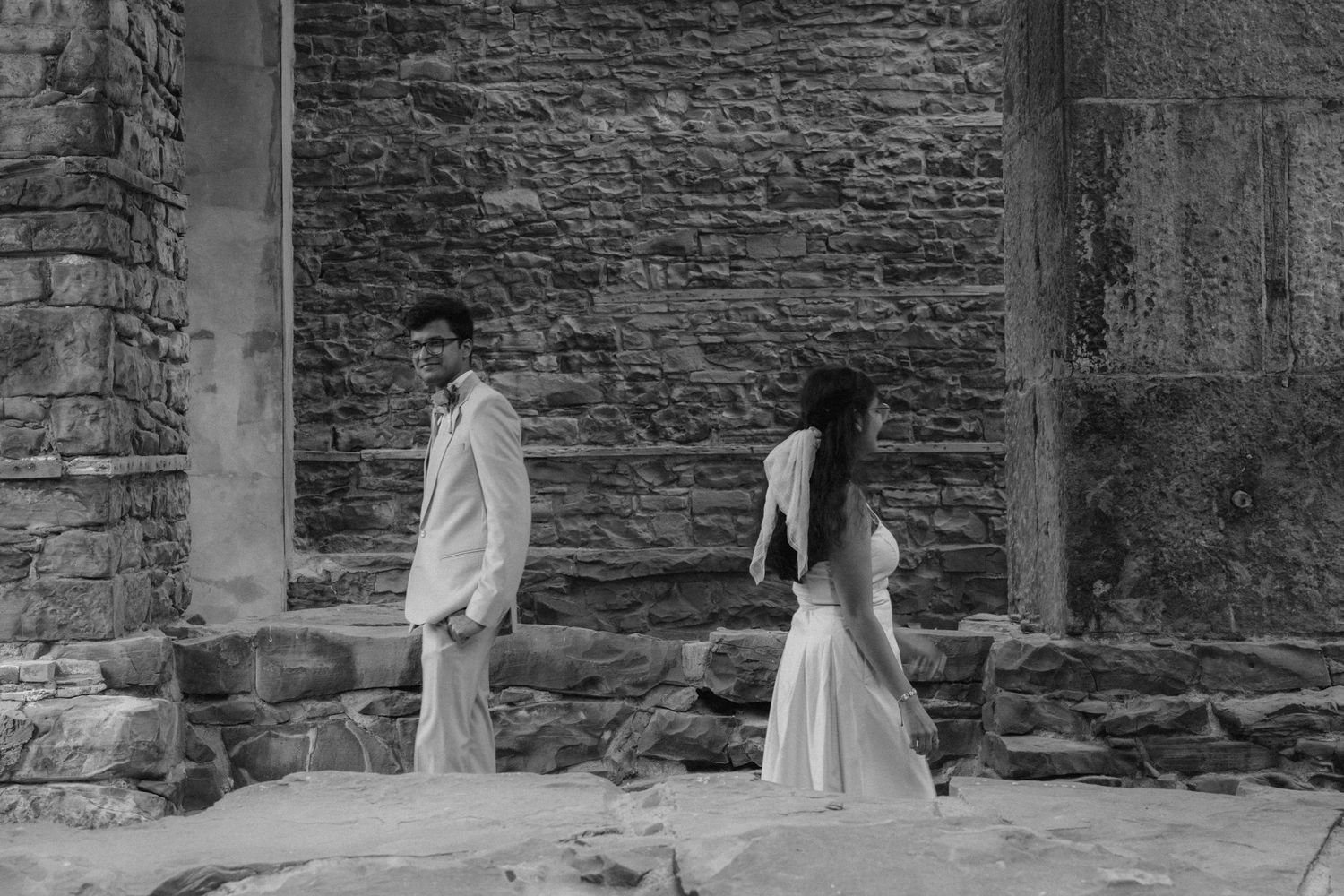A series of romantic poses under a historic stone colonnade. St. Josephs park wedding photographer