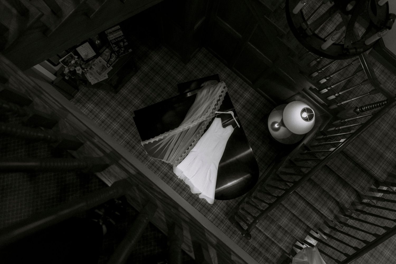 Dramatic black and white architectural shot of a staircase with shadows and light patterns.Rochester NY documentary wedding photography