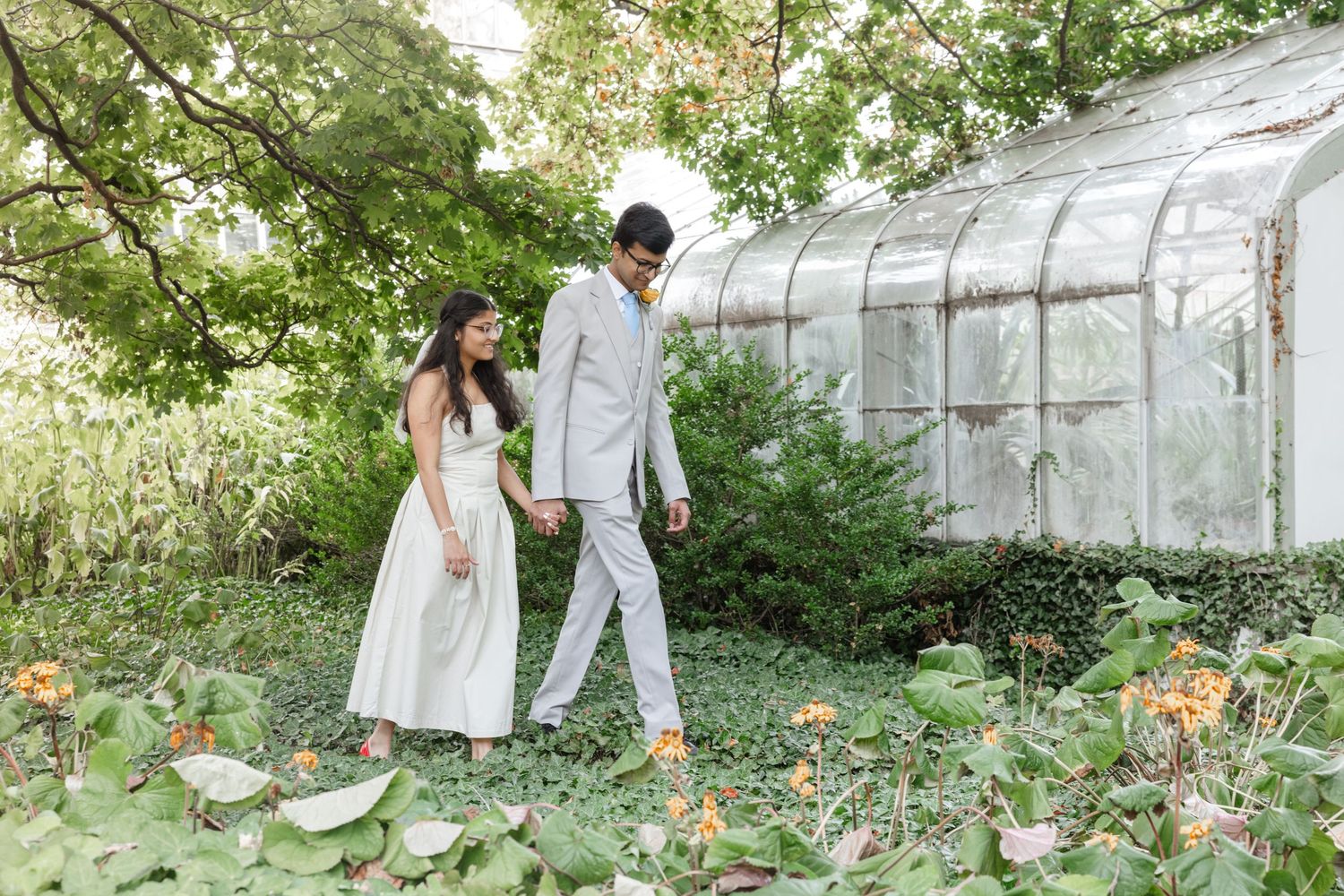 Elegant greenhouse garden setting with stone pathways and white florals. Rochester micro elopement photographer