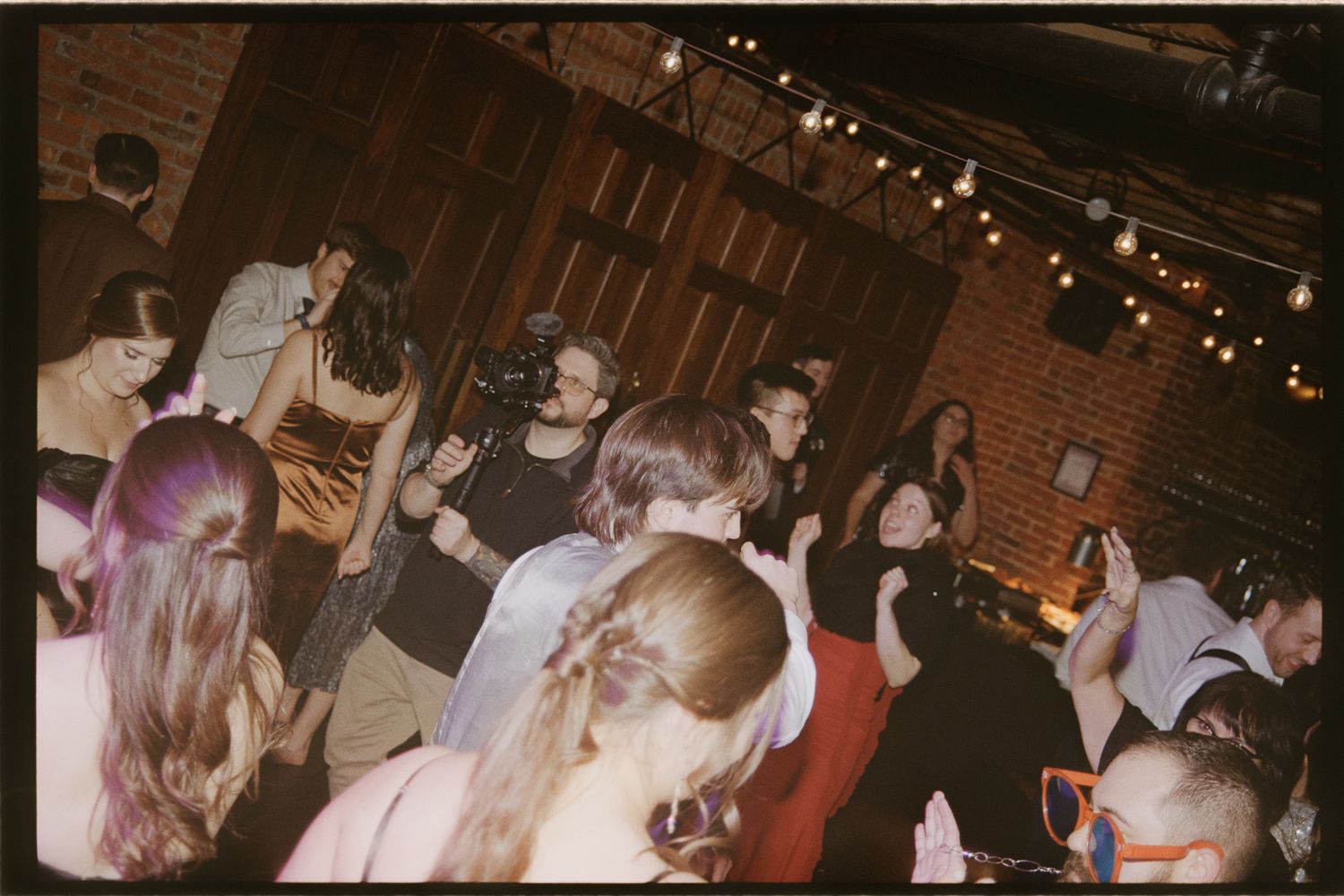 A sequence of blurry vintage photographs showing people dancing at what appears to be a party or social gathering.