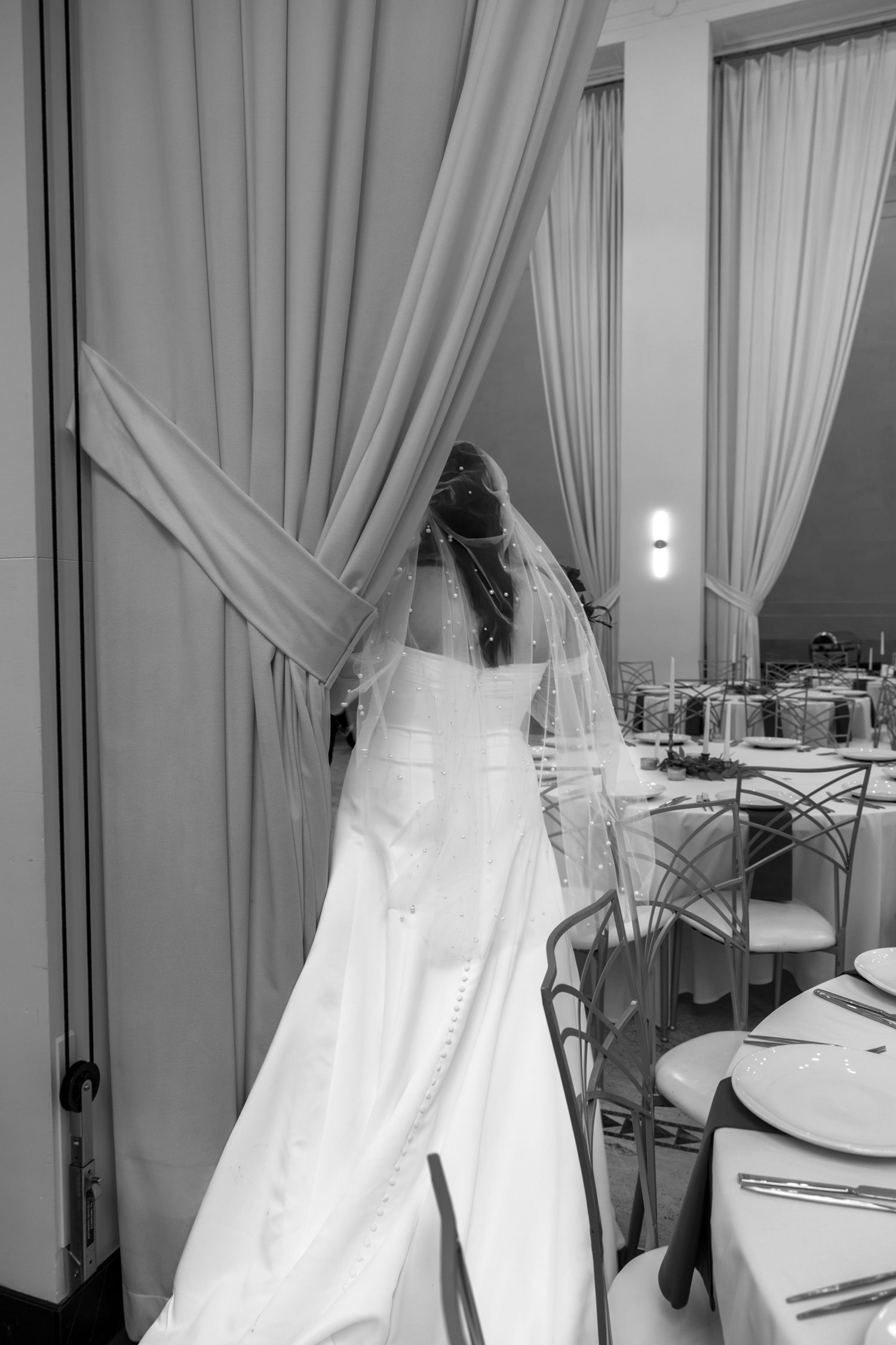 Wedding venue preparation showing white drapes and elegant table settings in natural light. Arbor Midtown wedding photographer