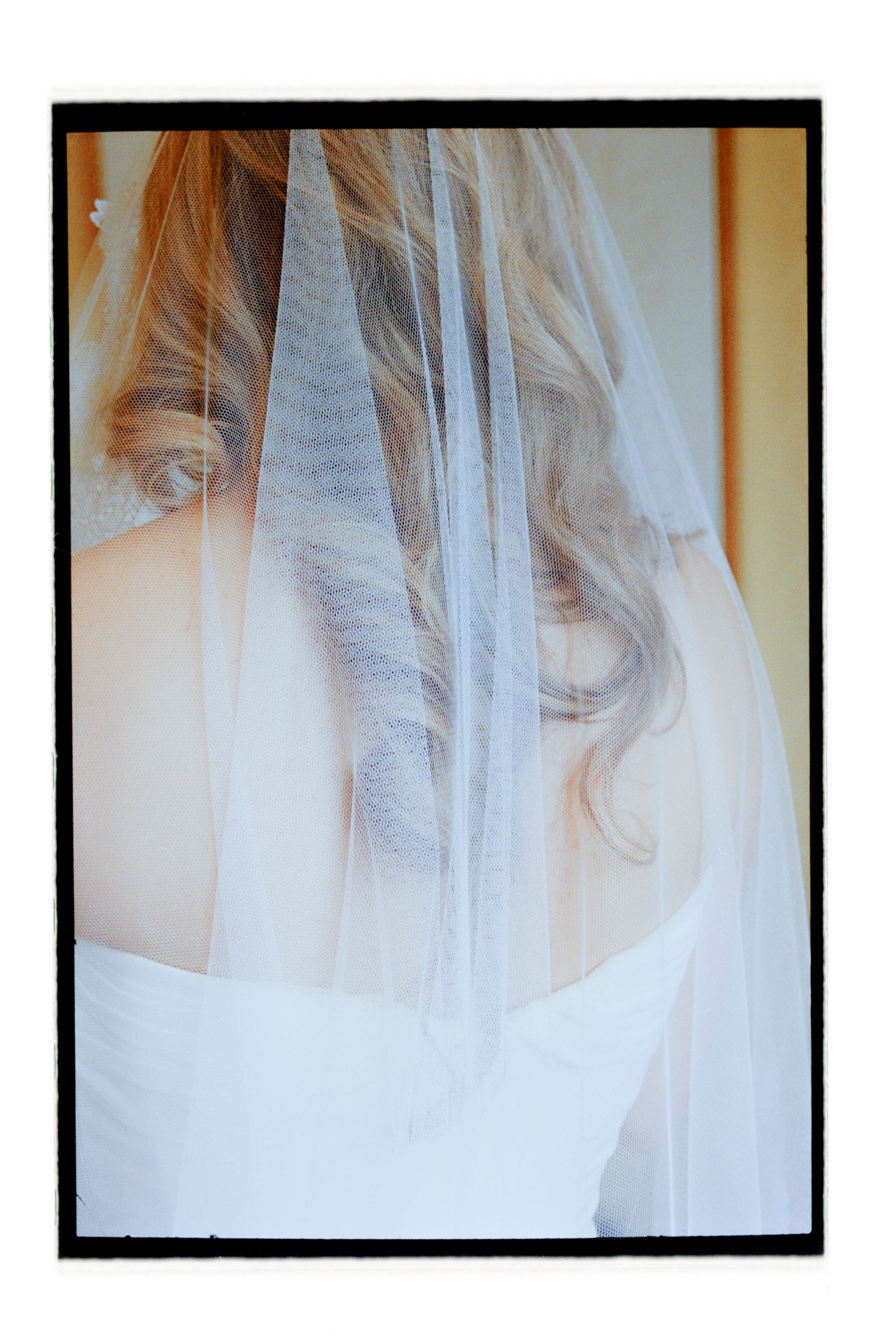 Ethereal close-up shots of white wedding veil fabric with soft lighting. Film wedding photographer NY