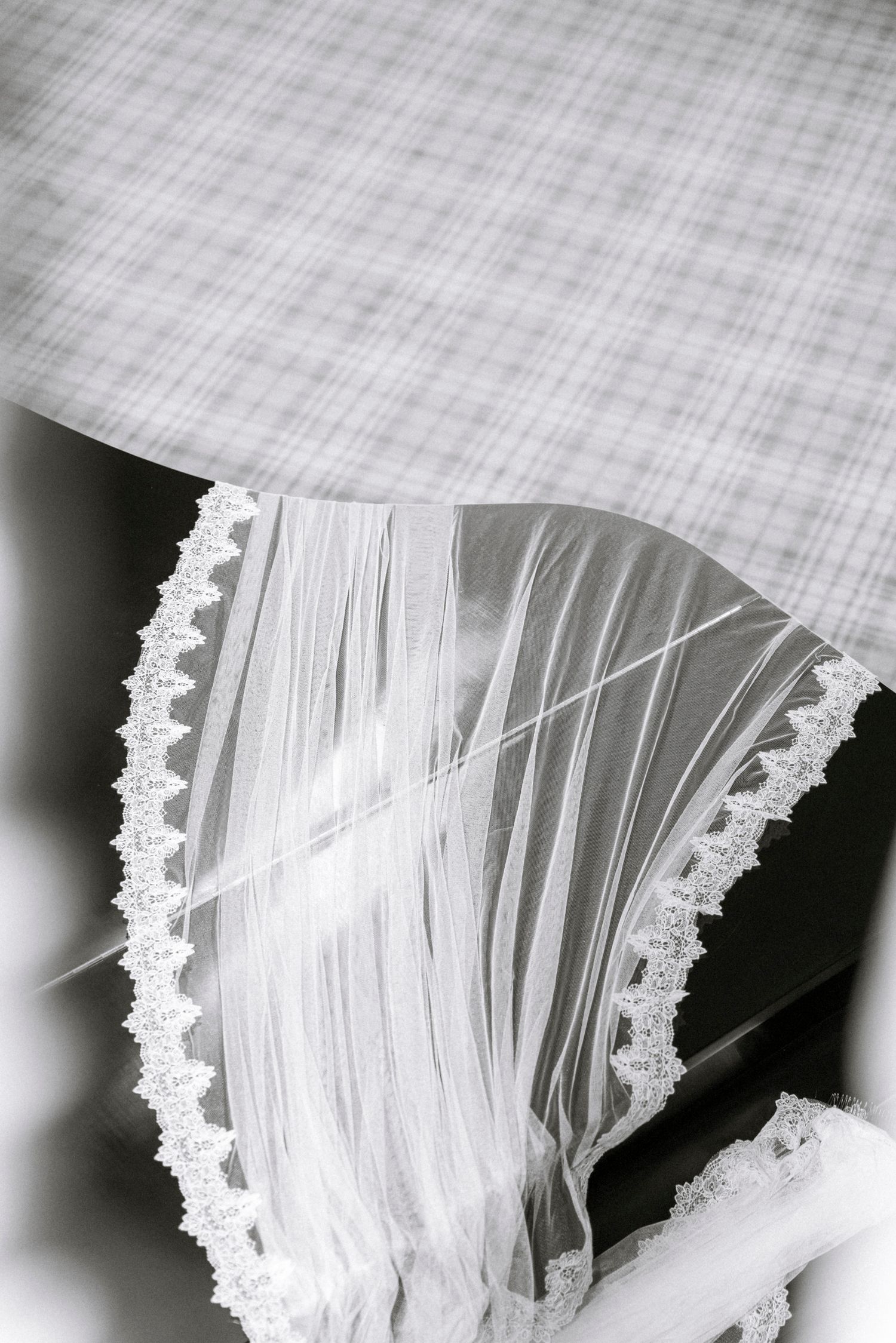 Close-up detail of white lace trim on a delicate wedding veil. Film wedding photographer Rochester  NY