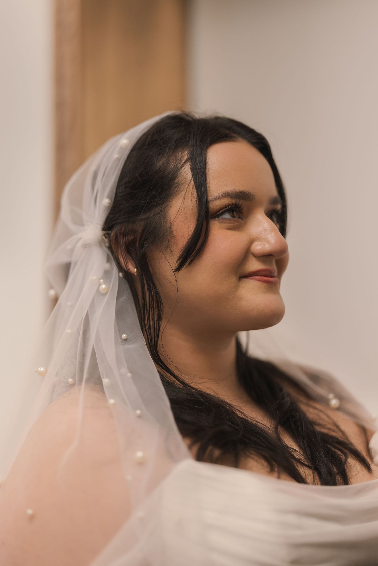 Close-up sequence of a bride wearing a delicate veil against a light background. Arbor Midtown wedding photographer