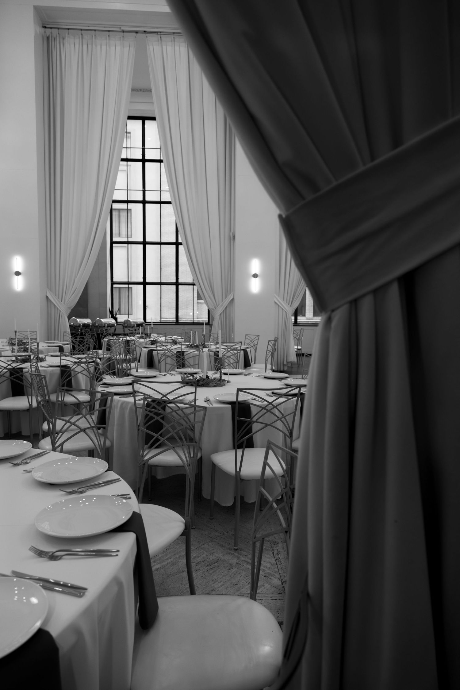 Elegant wedding reception venue with white tablecloths and draped curtains. Arbor Midtown wedding photographer