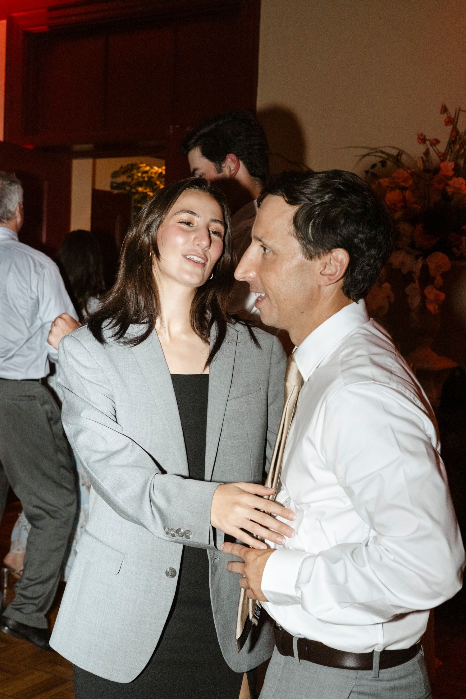 Dancing couples enjoying an intimate moment at an indoor celebration.Rochester NY documentary wedding photography