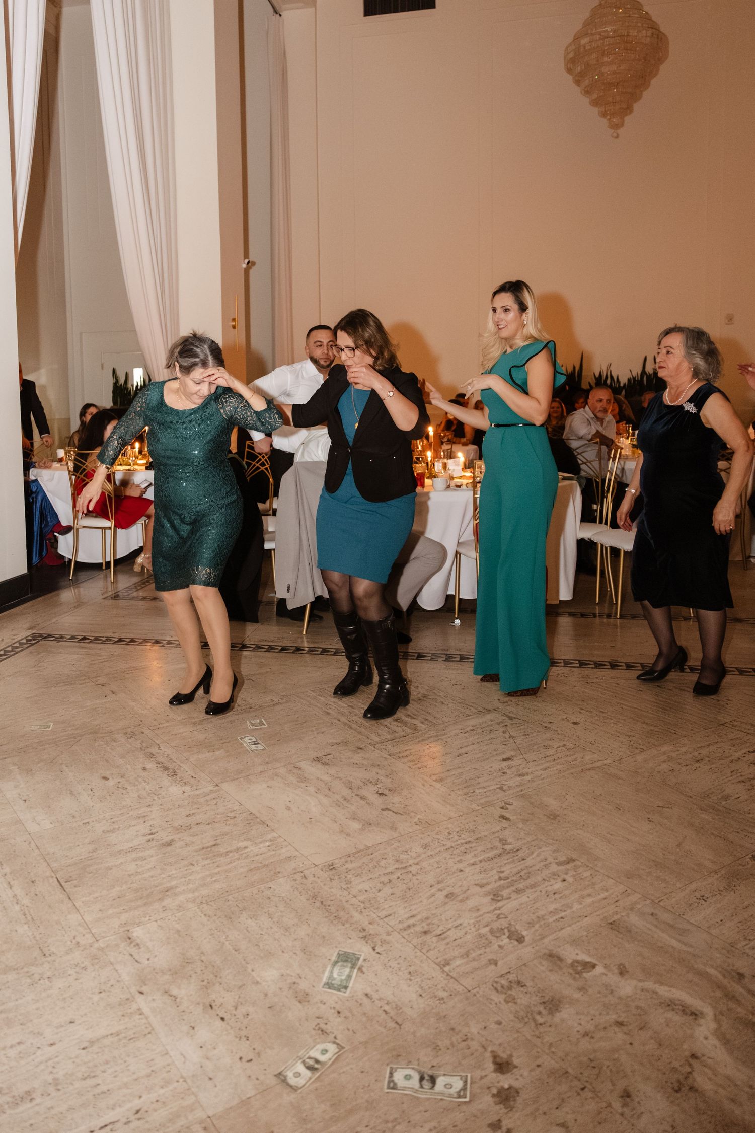 Wedding guests dancing and celebrating on a dance floor at an elegant indoor reception venue. Arbor Midtown wedding photographer