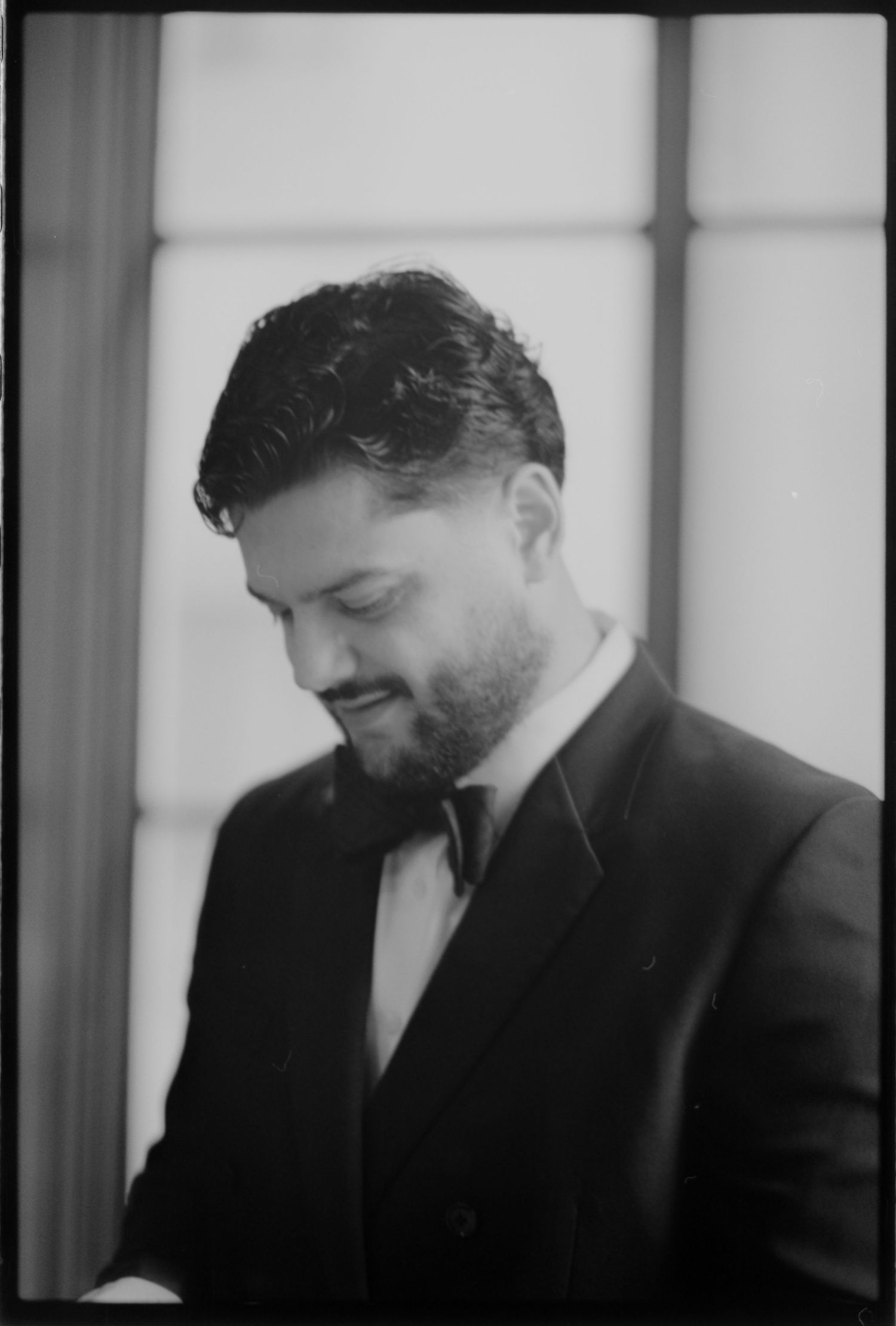 Side profile sequence of a groom in a black suit shown in black and white photography. Arbor Midtown wedding photographer
