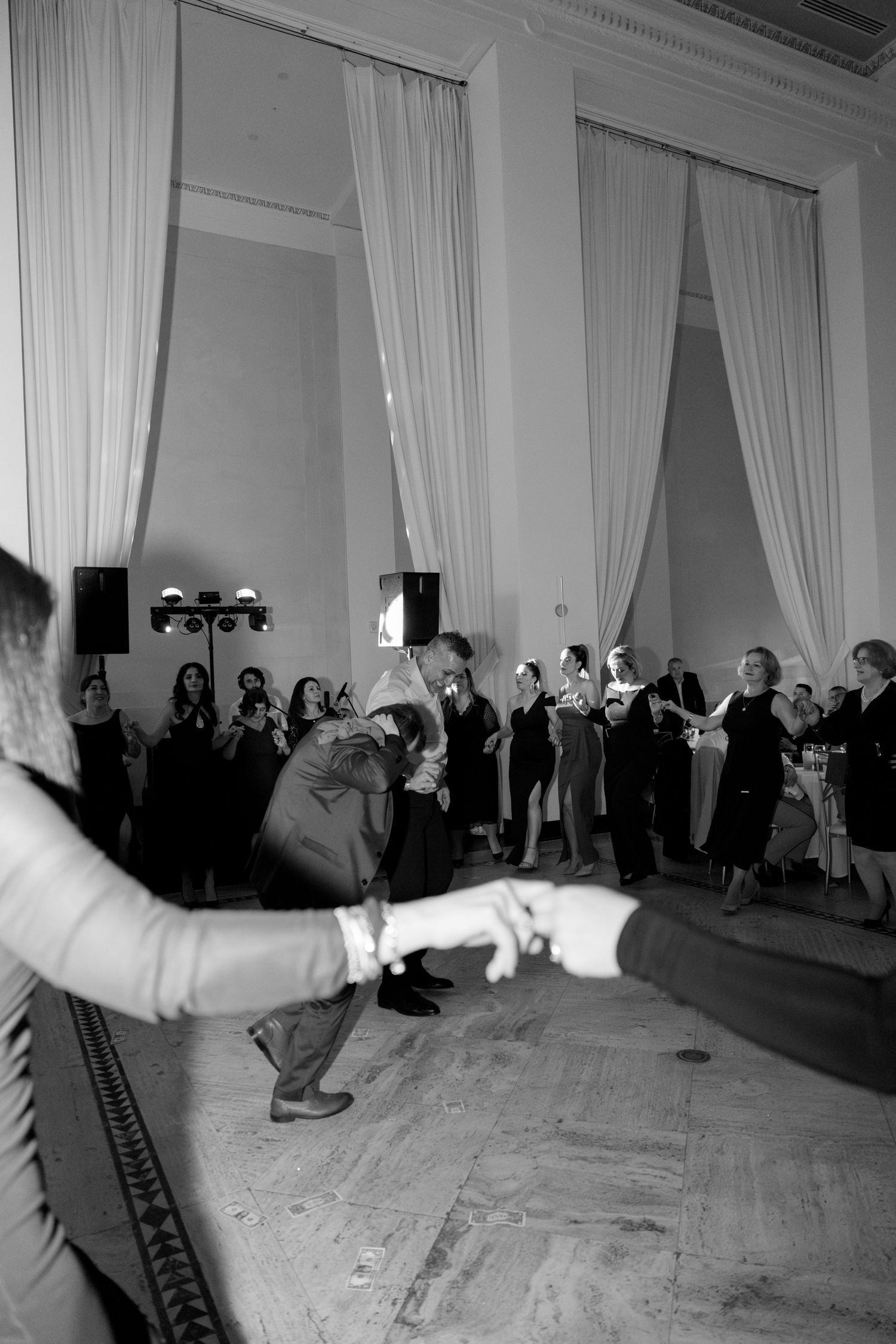 Black and white photos of guests performing dance moves at a wedding celebration. Rochester NY film wedding photographer