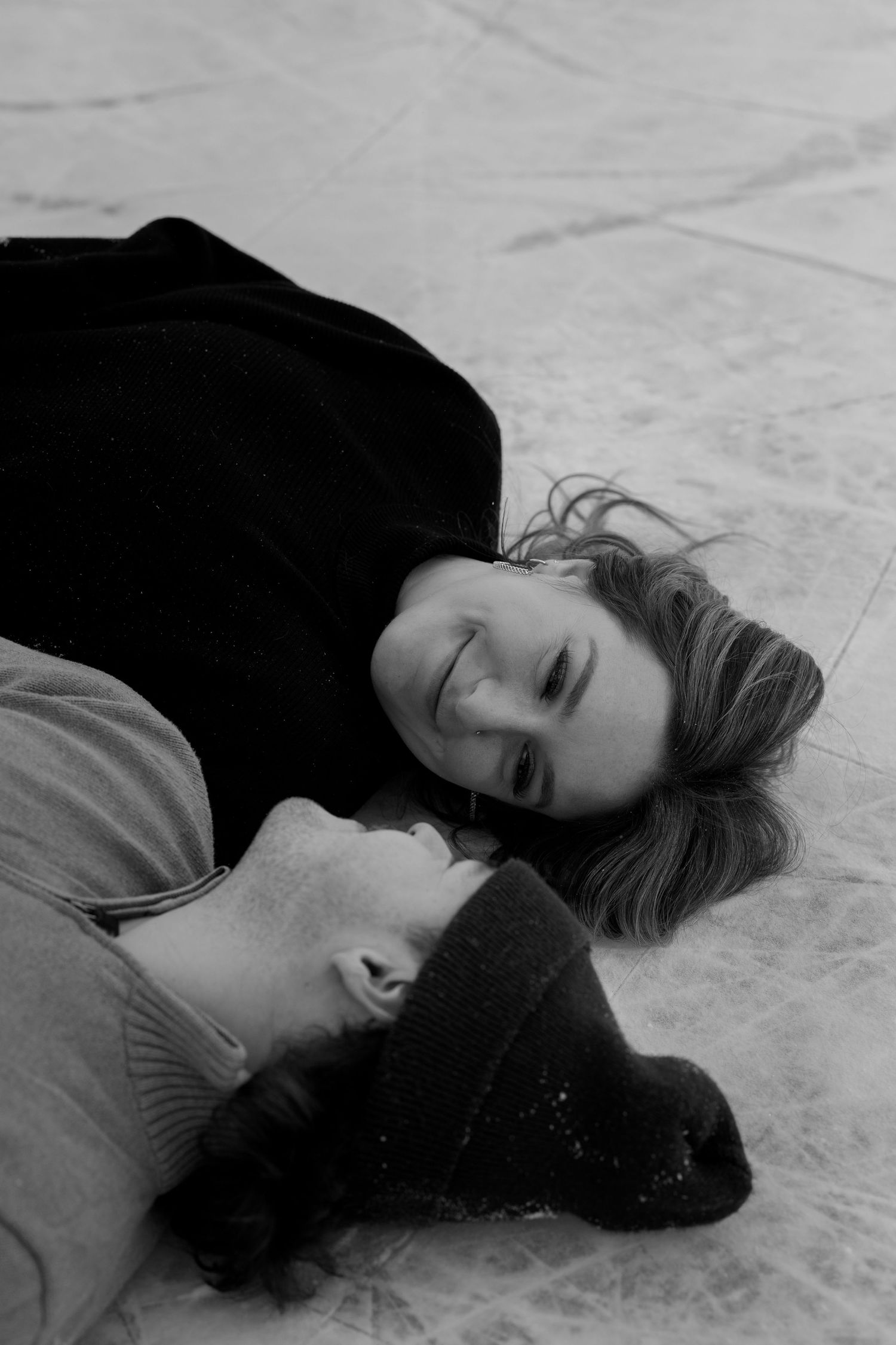 A series of black and white photographs showing someone lying on the ground with their hair spread out.