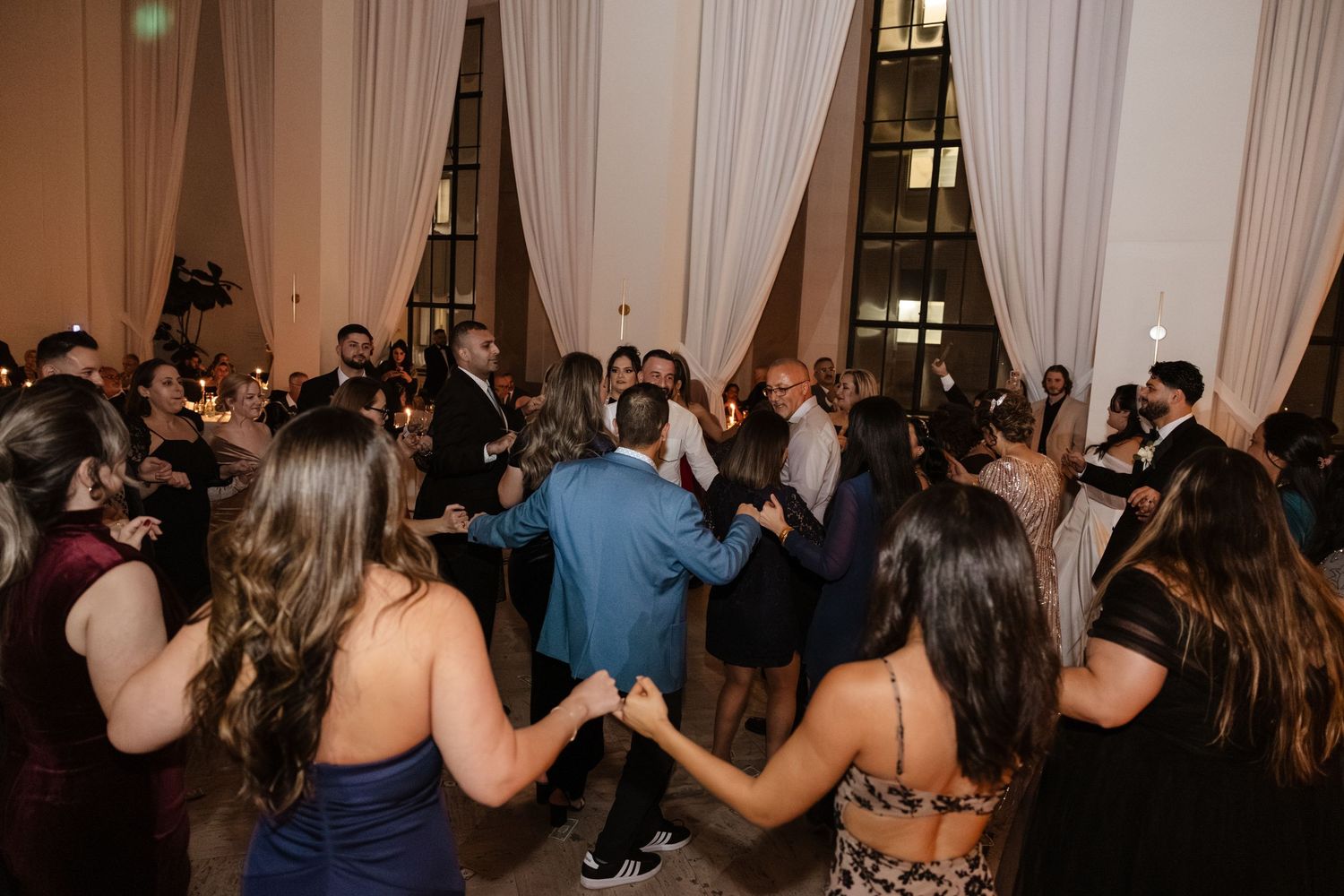 Wedding reception dance floor filled with guests enjoying the celebration. . Arbor Midtown wedding photographer