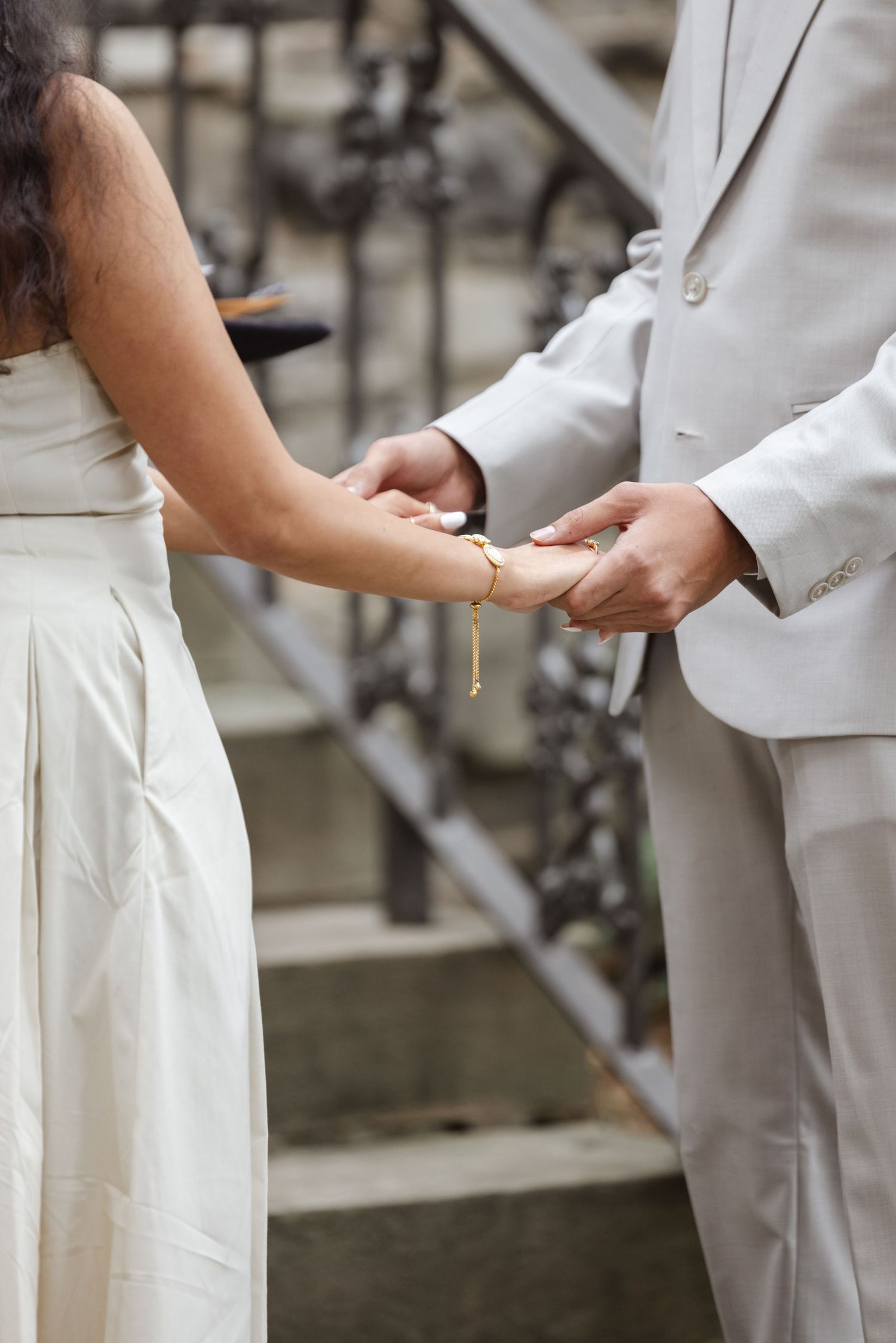 Close-up of couple holding hands during outdoor wedding ceremony.  St. Josephs park wedding photographer