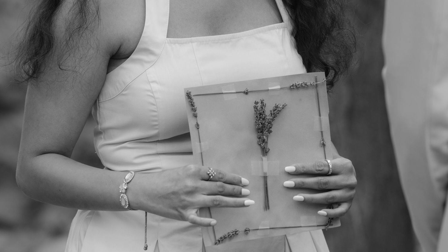 Person holding vintage paper with dried lavender during ceremony.  St. Josephs park wedding photographer