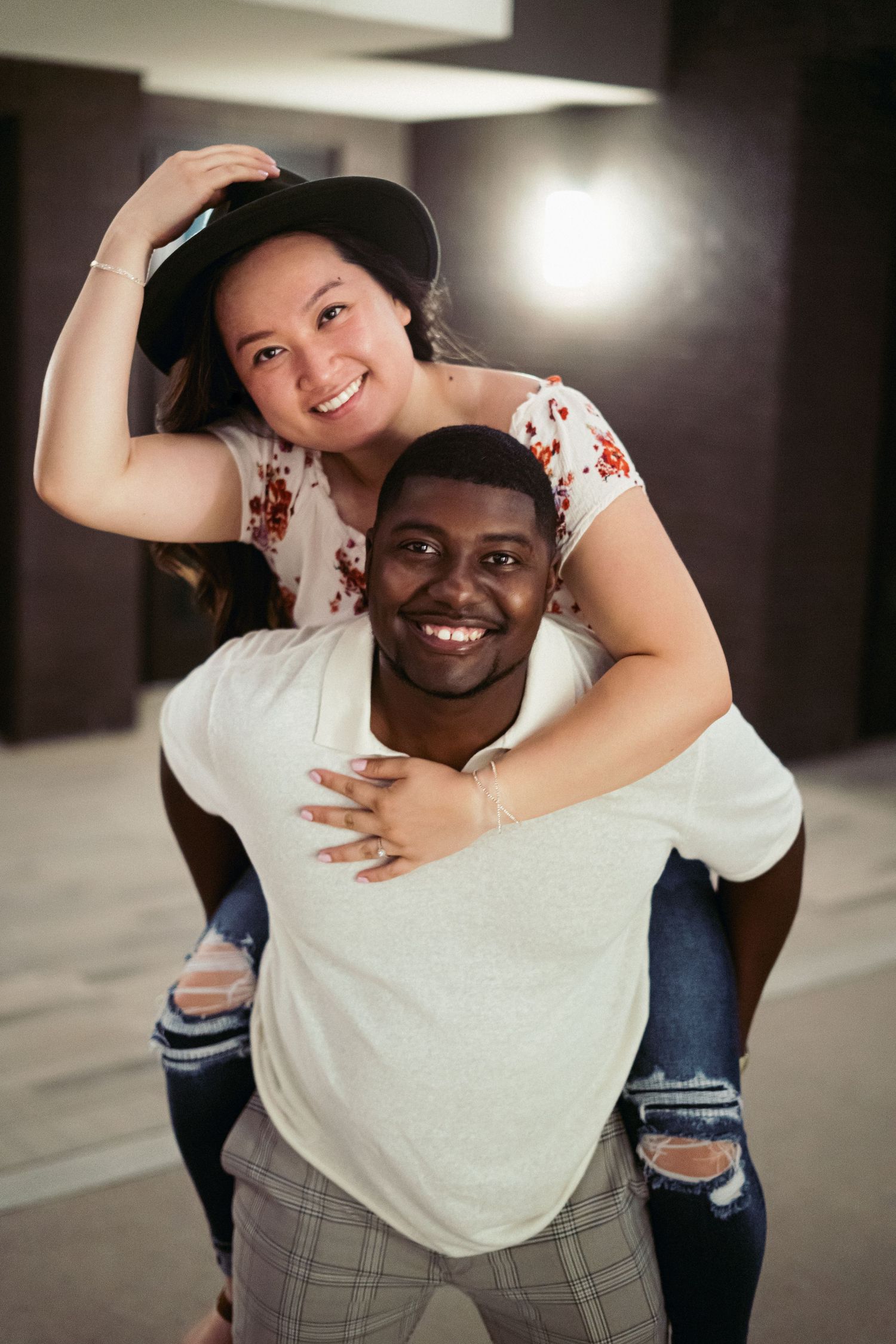 Playful interracial couple piggyback portrait Austin - fun engagement photography session