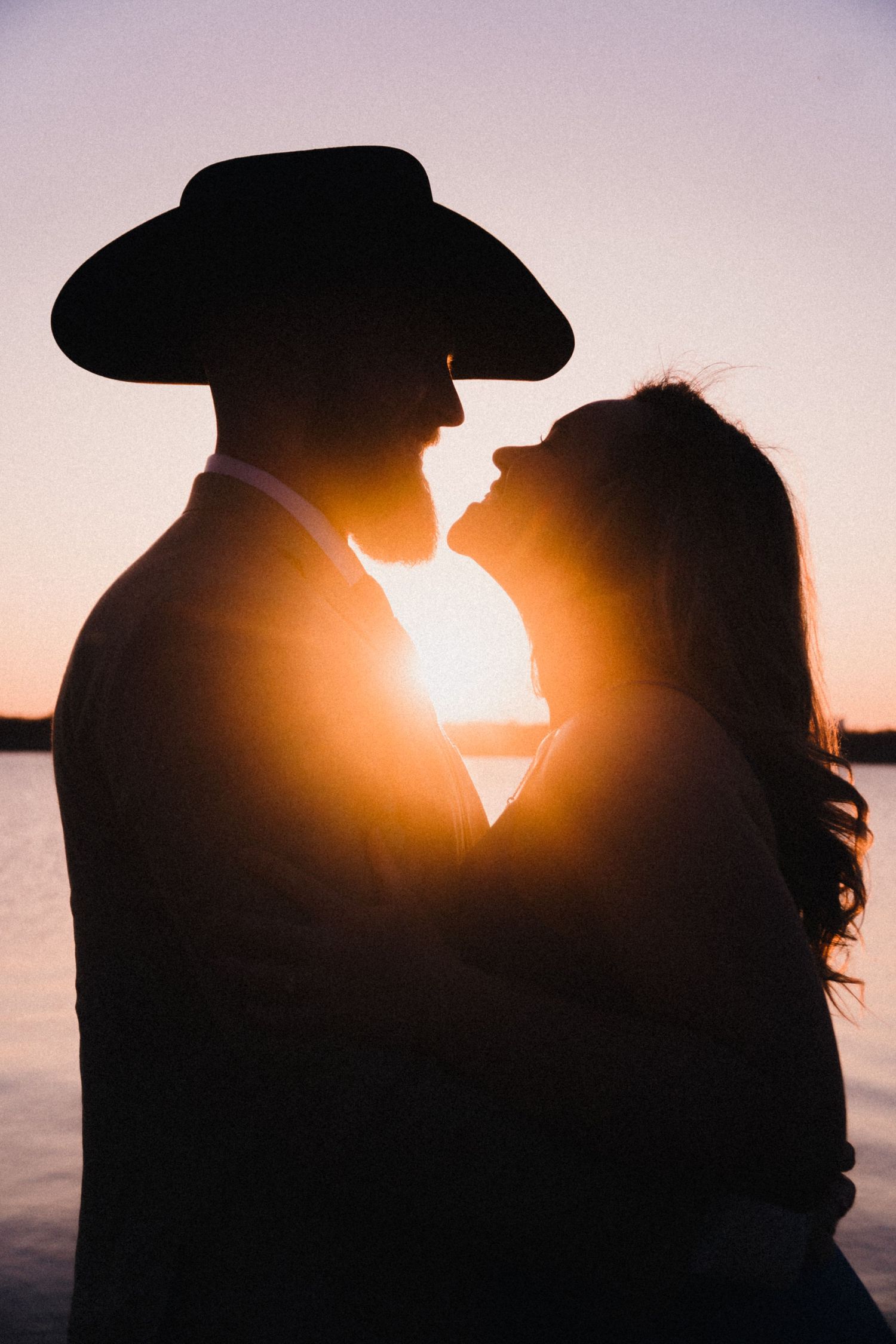Romantic couple silhouette at Texas sunset - golden hour engagement photography Austin