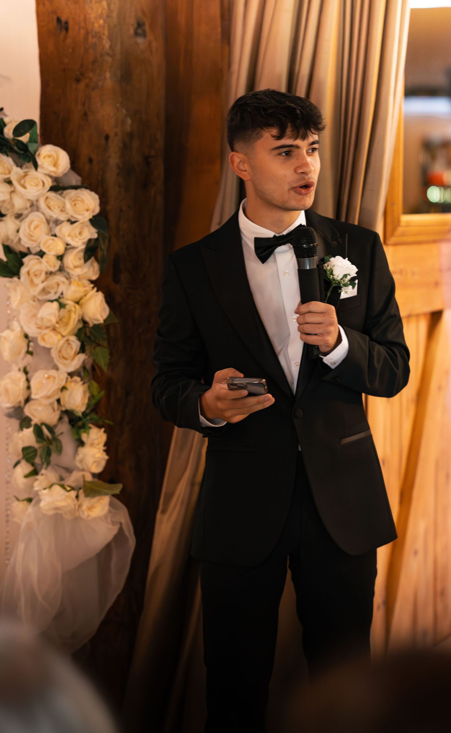 Best man delivering a speech prompted by his IPhone notes