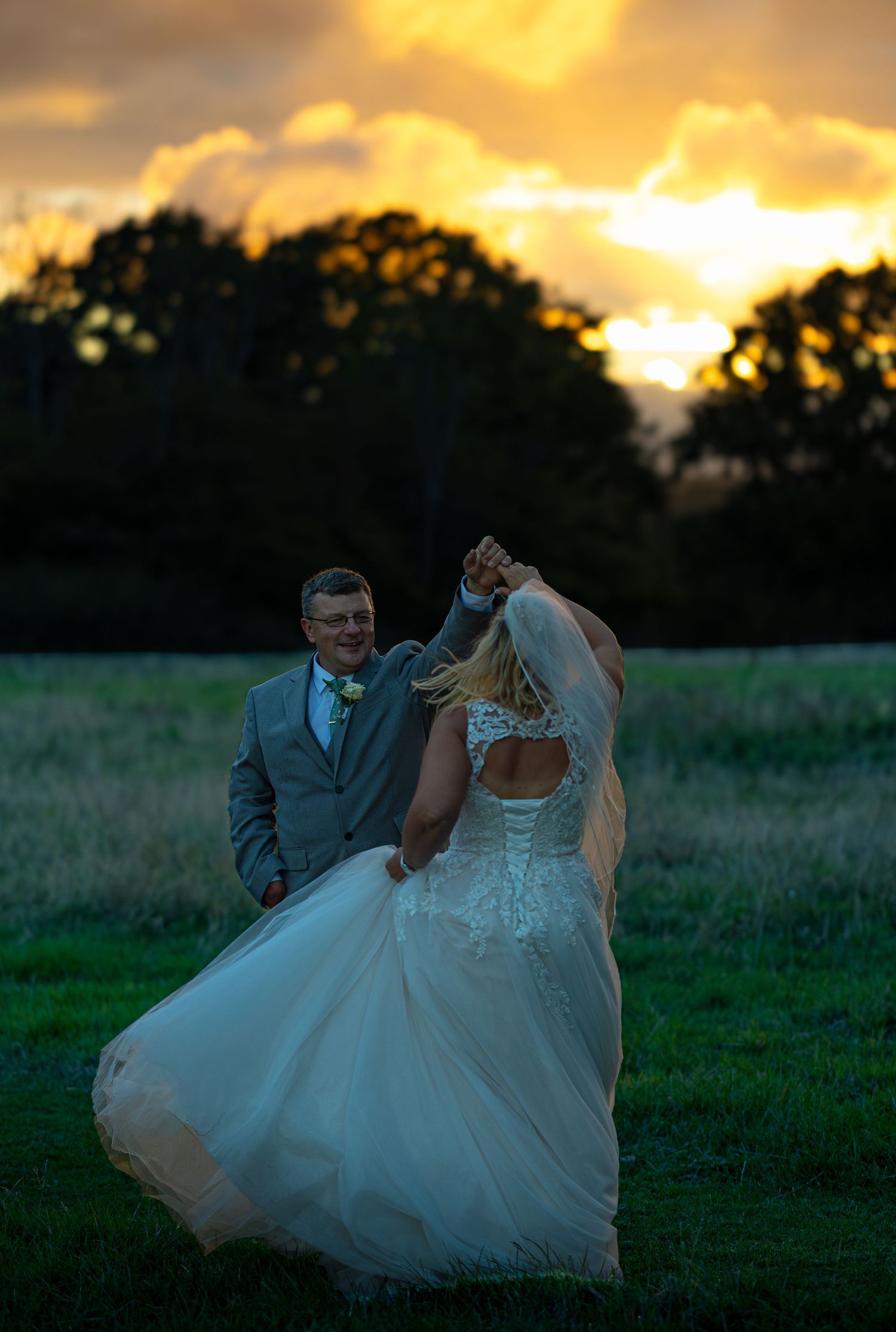 Bride and groom dancing in the setting sun
