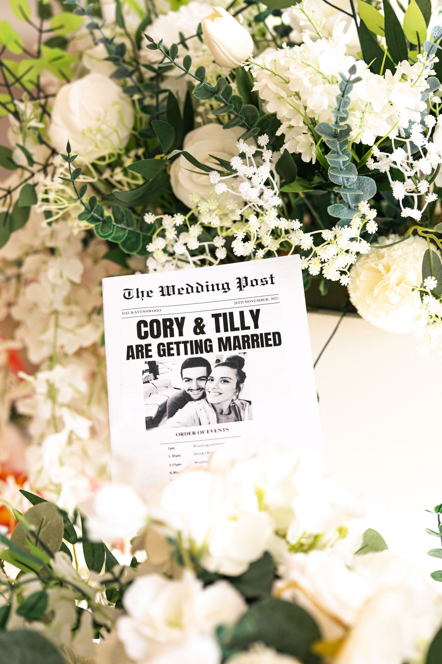 Personalised weddings flier accompanied with wedding flower display of white roses